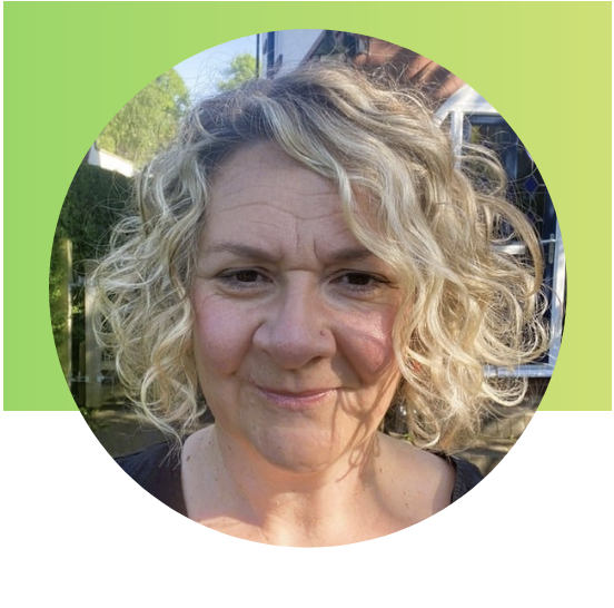 Woman with blond curly hair smiling into the carmera