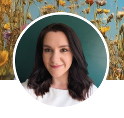 Profile image of women looking into the camera with shoulder length dark hair and a white top.