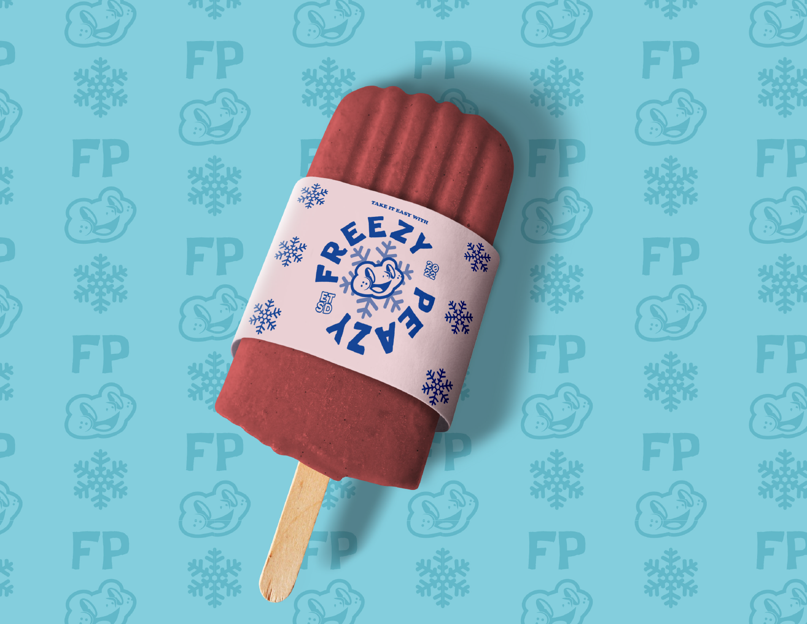 A red popsicle with a white label that reads "FREZZY PEAS" surrounded by snowflakes and a cartoon character, against a blue background with snowflakes and cartoon faces.
