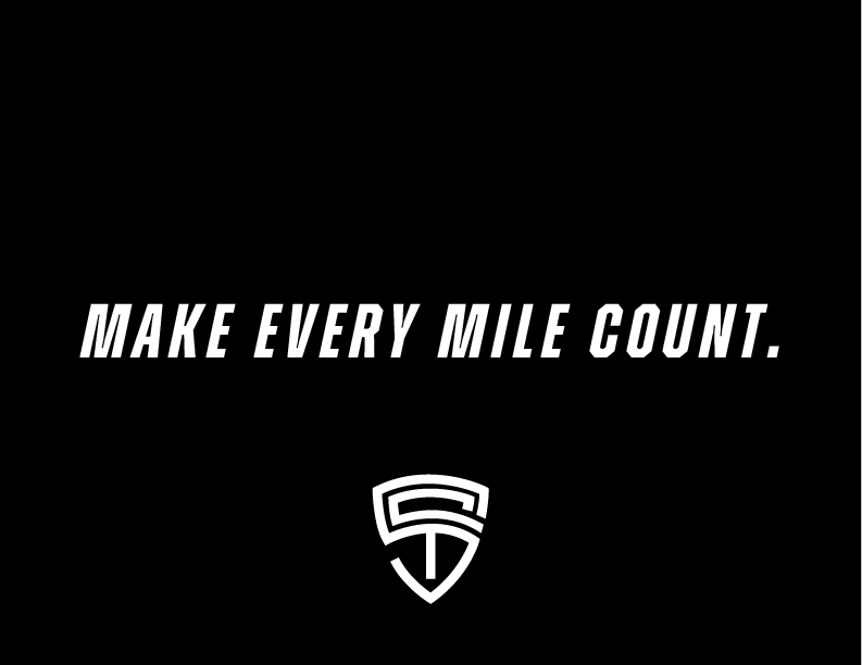 Black background with white text saying "MAKE EVERY MILE COUNT." and a stylized shield logo beneath it.