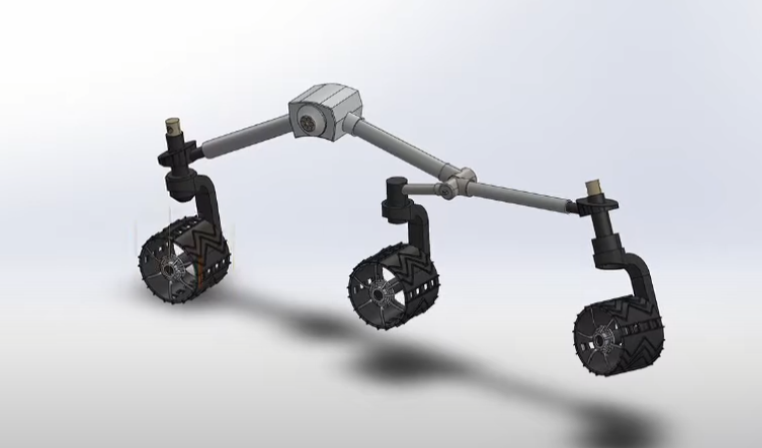 A mechanical model of a multisensory wheel-based device with three wheels connected by a central frame and motor on a plain background.