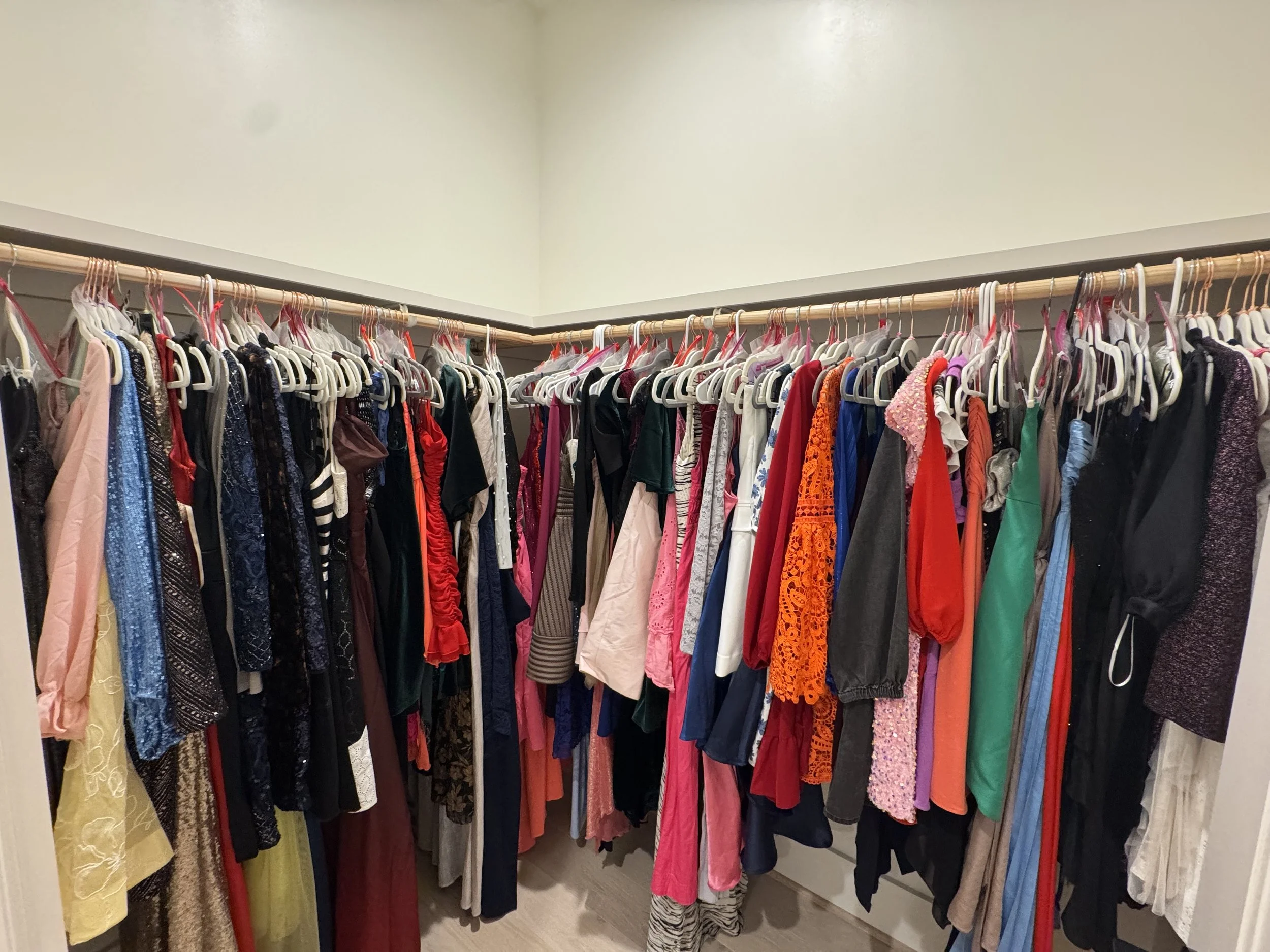 A closet with dresses collected with Let-Her Dress, ready for distribution.