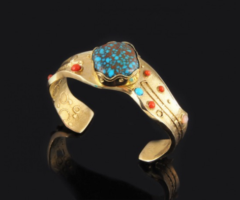 GOLD LADY'S BRACELET. Medium 14K gold metal, tufa stone cast, size 5 1/2 lady's bracelet. Dimensions: 1 1/4"×3"×2". Stones: turquoise, coral, sugilite, lapis, mother-of-pearl shell, jet, white opal. Project time: 2 months. Cost: $45,000. Down payment