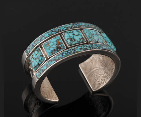KINGMAN SPIDERWEB BRACELET. Made with whatever high quality spiderweb turquoise is available. Spiderweb cabochons and channel work as well, 4 Blue Corn Yeis, fabricated silver. Dimensions: 1 1/4"×3"×2". Stones: this bracelet features high blue Kingma
