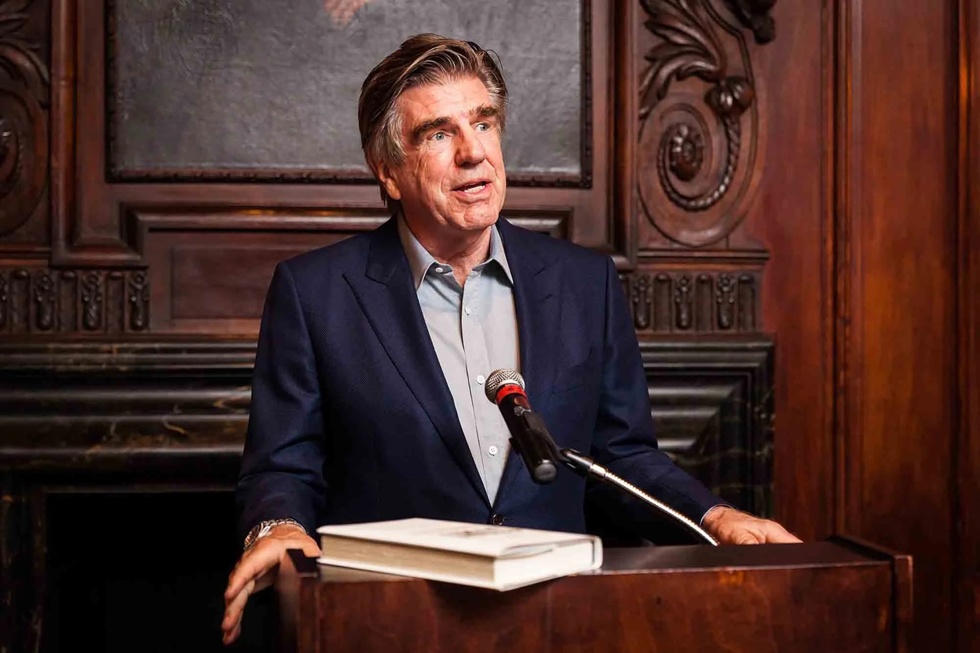 CEO Tom Freston speaking at a podium by San Antonio corporate event photographer, Kelly Williams