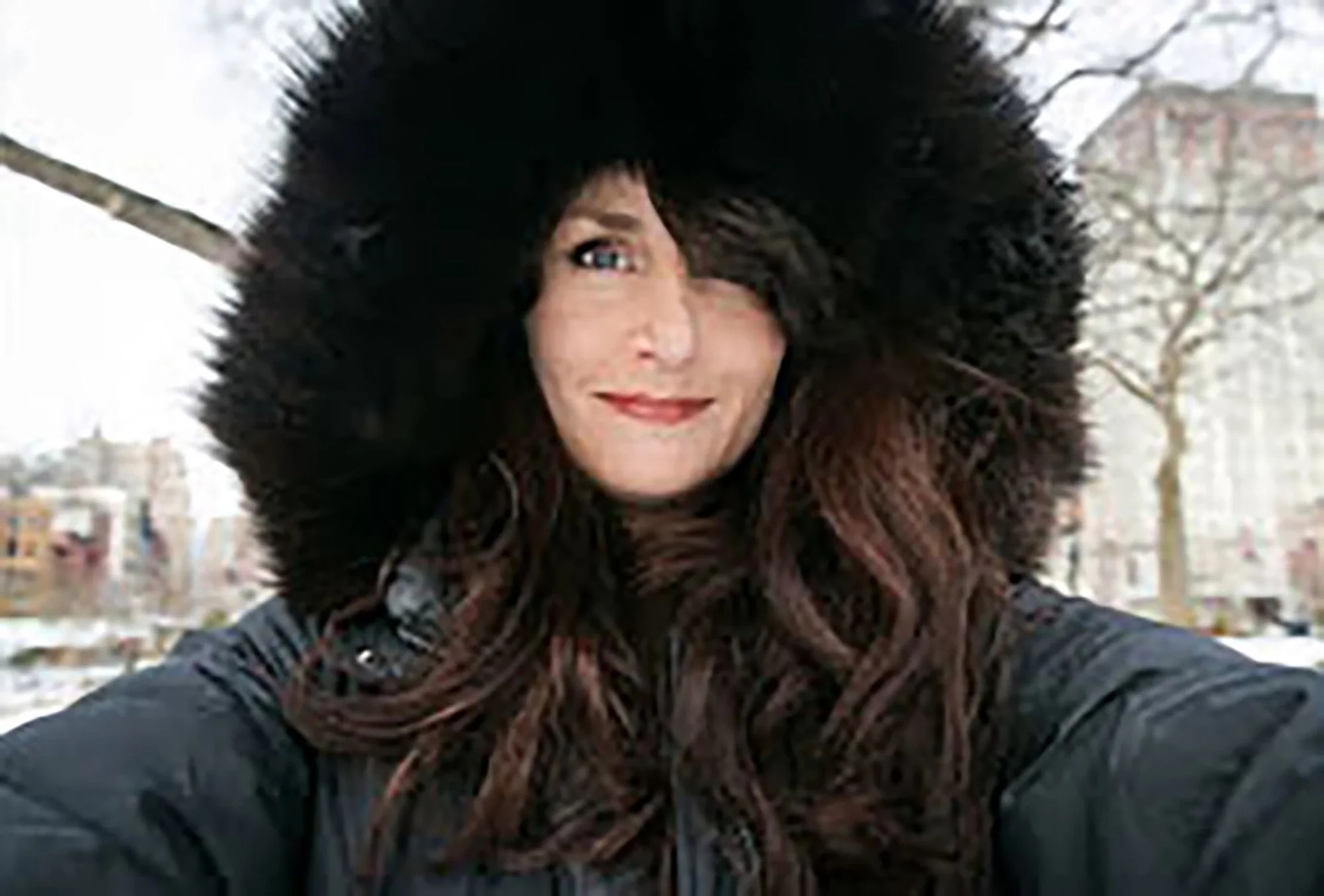Los Angeles travel photographer and photojournalist, Kelly Williams, wearing a black fur-trimmed jacket