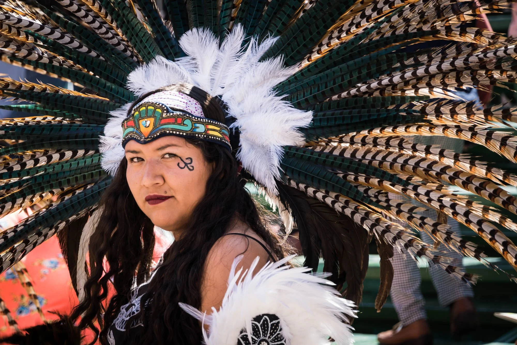 An indigenous woman wearing a feather headdress in Guanajuato, Mexico photographed by Los Angeles travel photographer Kelly Williams
