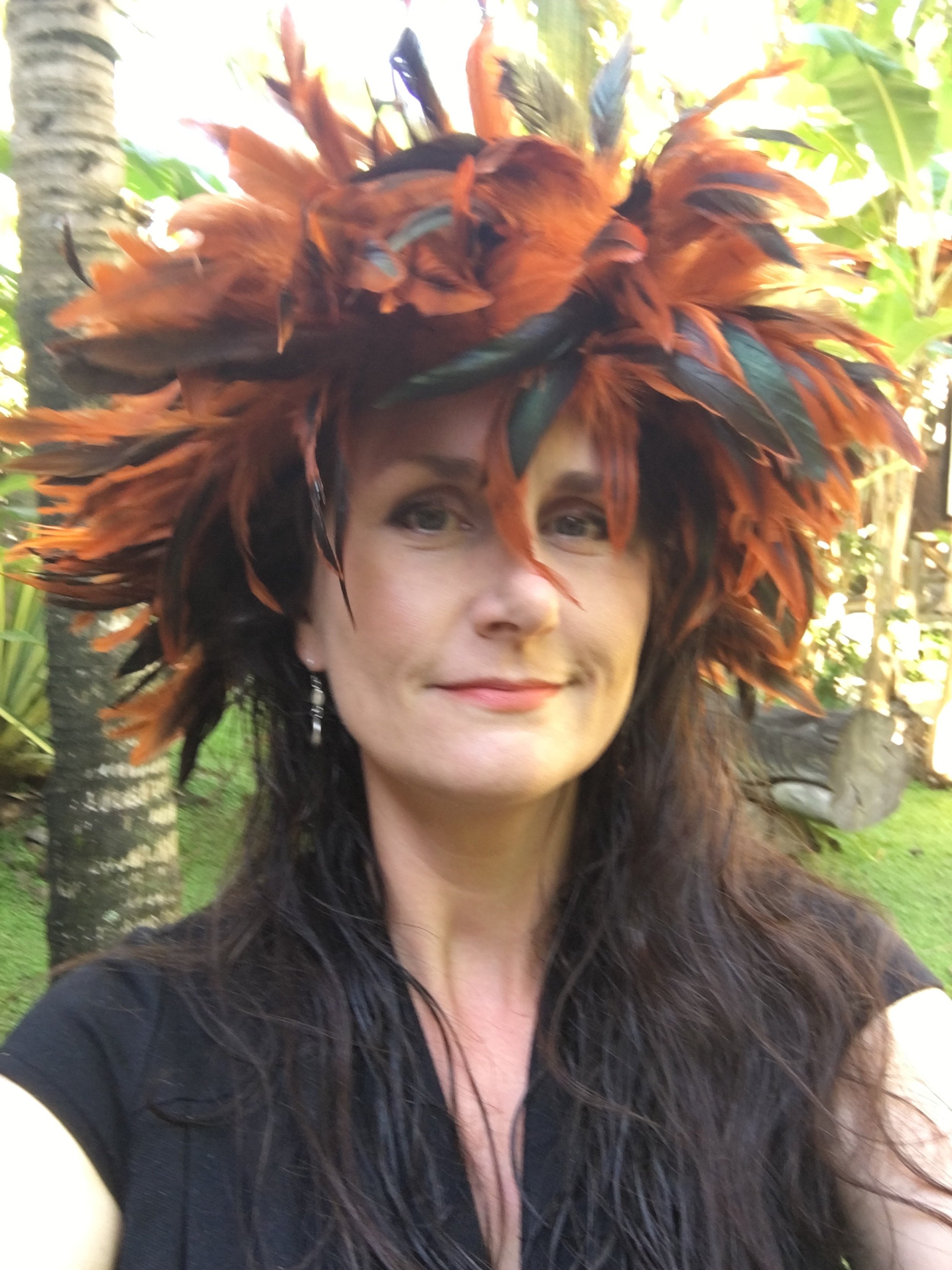 Los Angeles travel photographer and photojournalist, Kelly Williams, wearing an orange feather crown