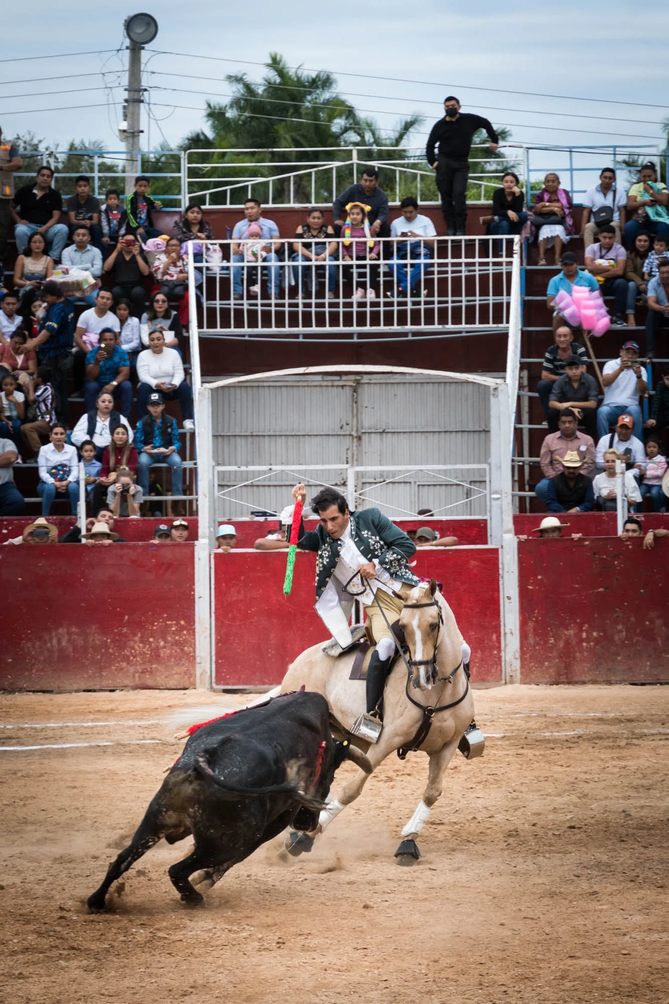 A matador on a horse about to stab a bull in Mexico in front of a crowd photographed by Los Angeles travel photographer Kelly Williams