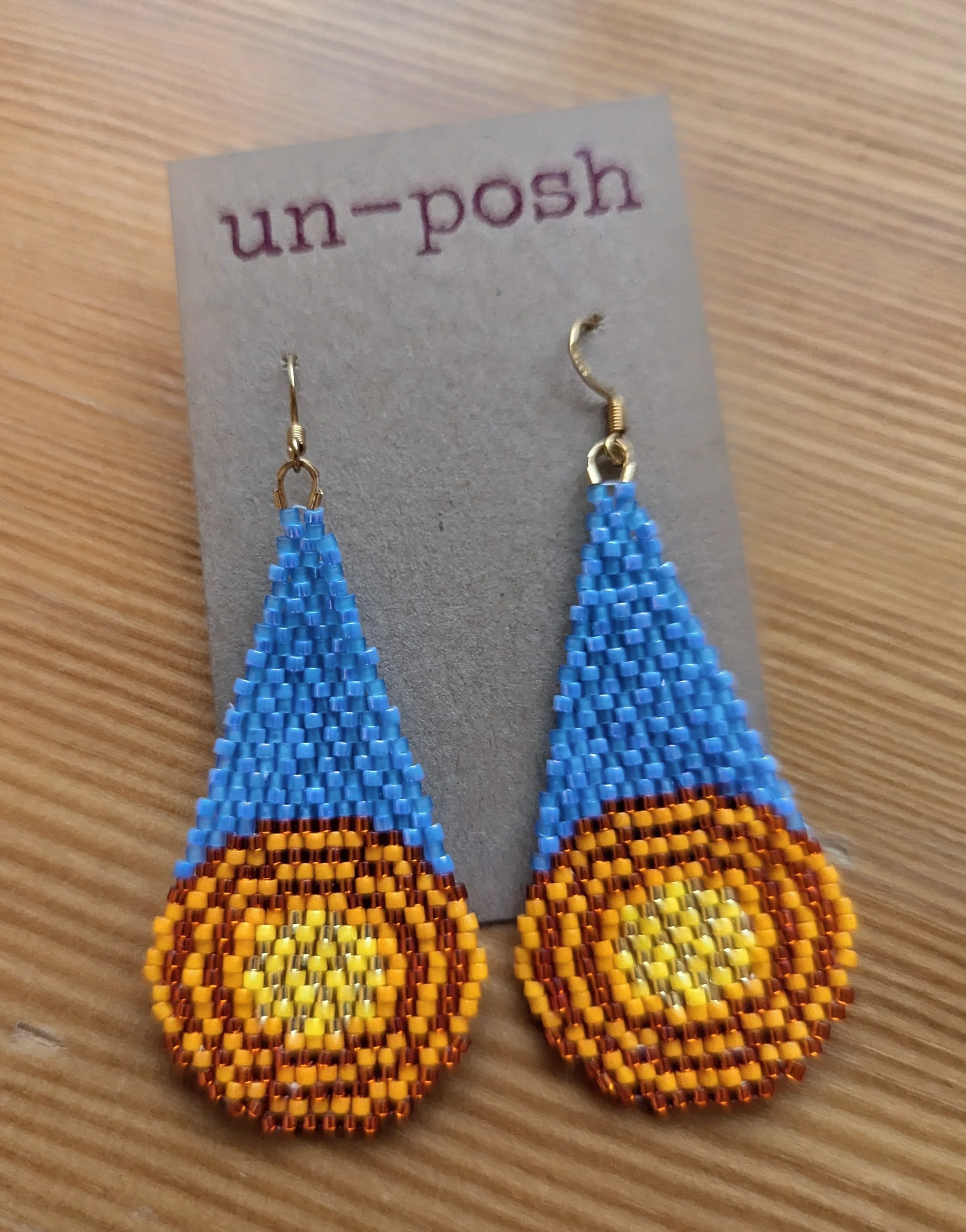 MOD earrings, yellow target on sky blue tail