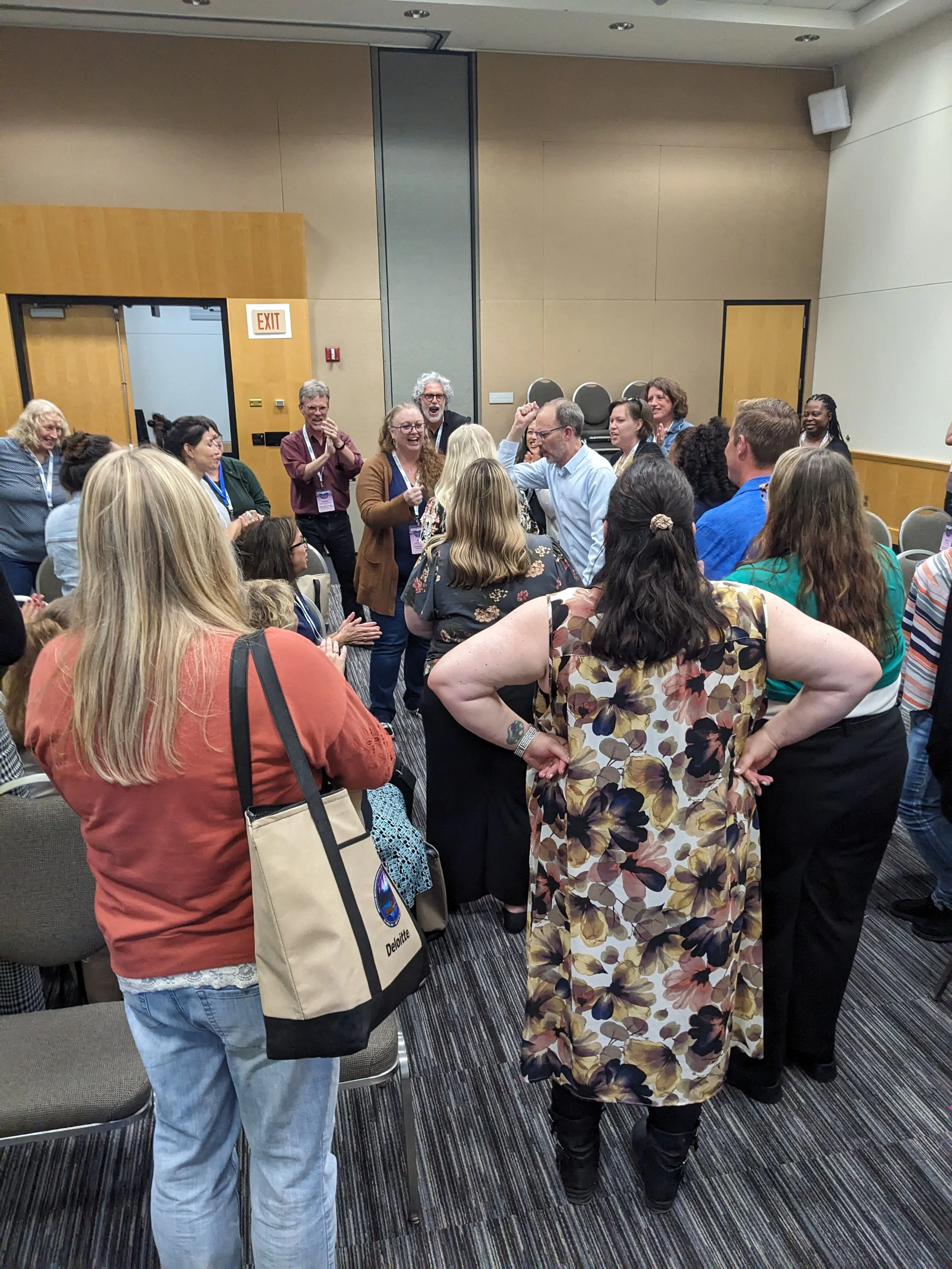 Participants in a professional development workshop in a rock, paper, scissors battle