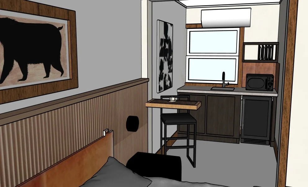 Interior of a small kitchen and bedroom area with a bed, wall art, a bar-height counter with a stool, a window, and kitchen appliances.