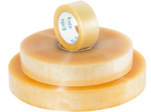 A modern wooden building with large glass windows, situated in a mountainous landscape with grassy terrain and sparse trees.