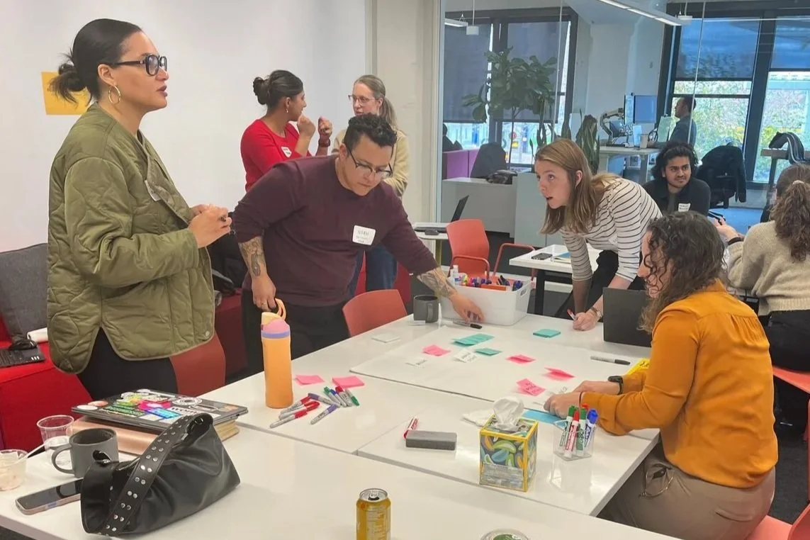 ASANDC Executive Director Tatiana Freeman meets with staff from Hammel, Green and Abhrahamson to discuss redesigning the organization’s office at 360 University Ave W for intentional community use in October 2025. 