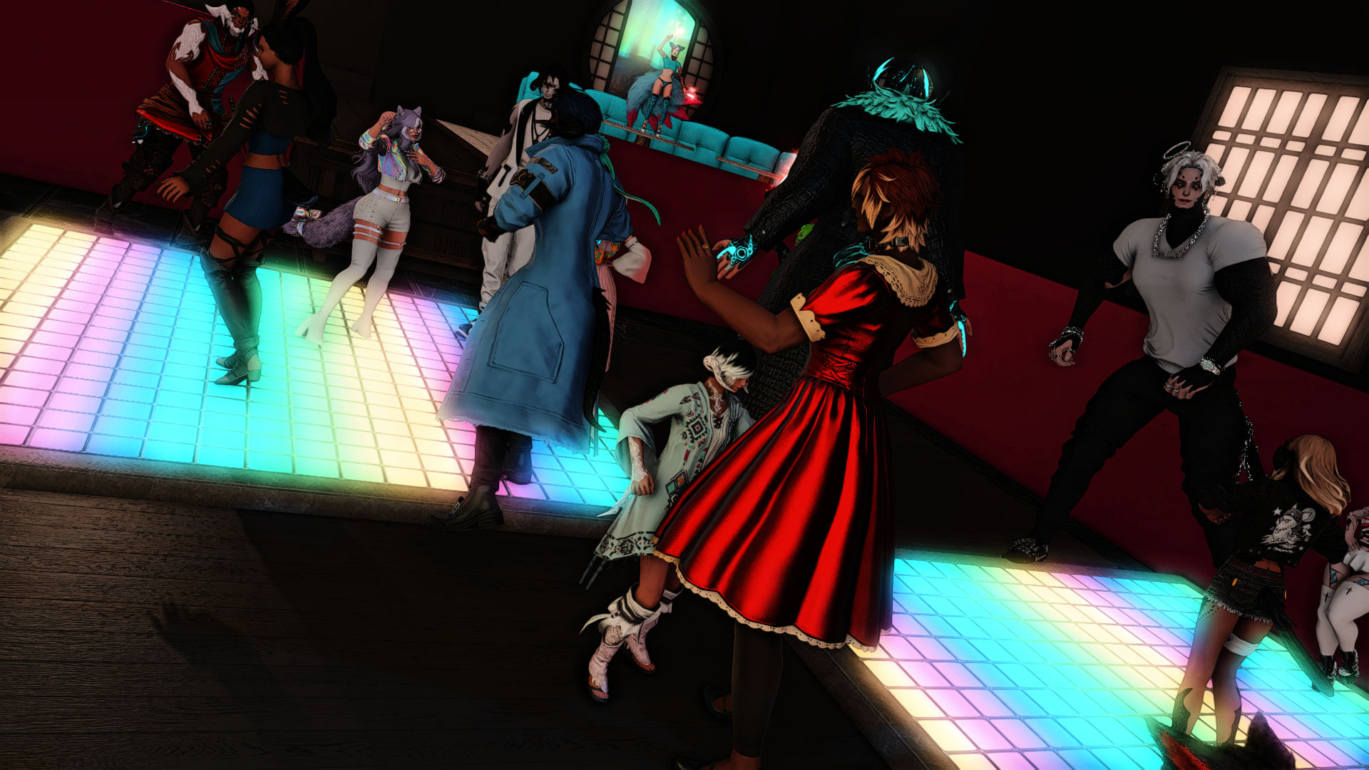 People dancing on a colorful, glowing dance floor in a dark nightclub with a red wall and a raised platform in the background.