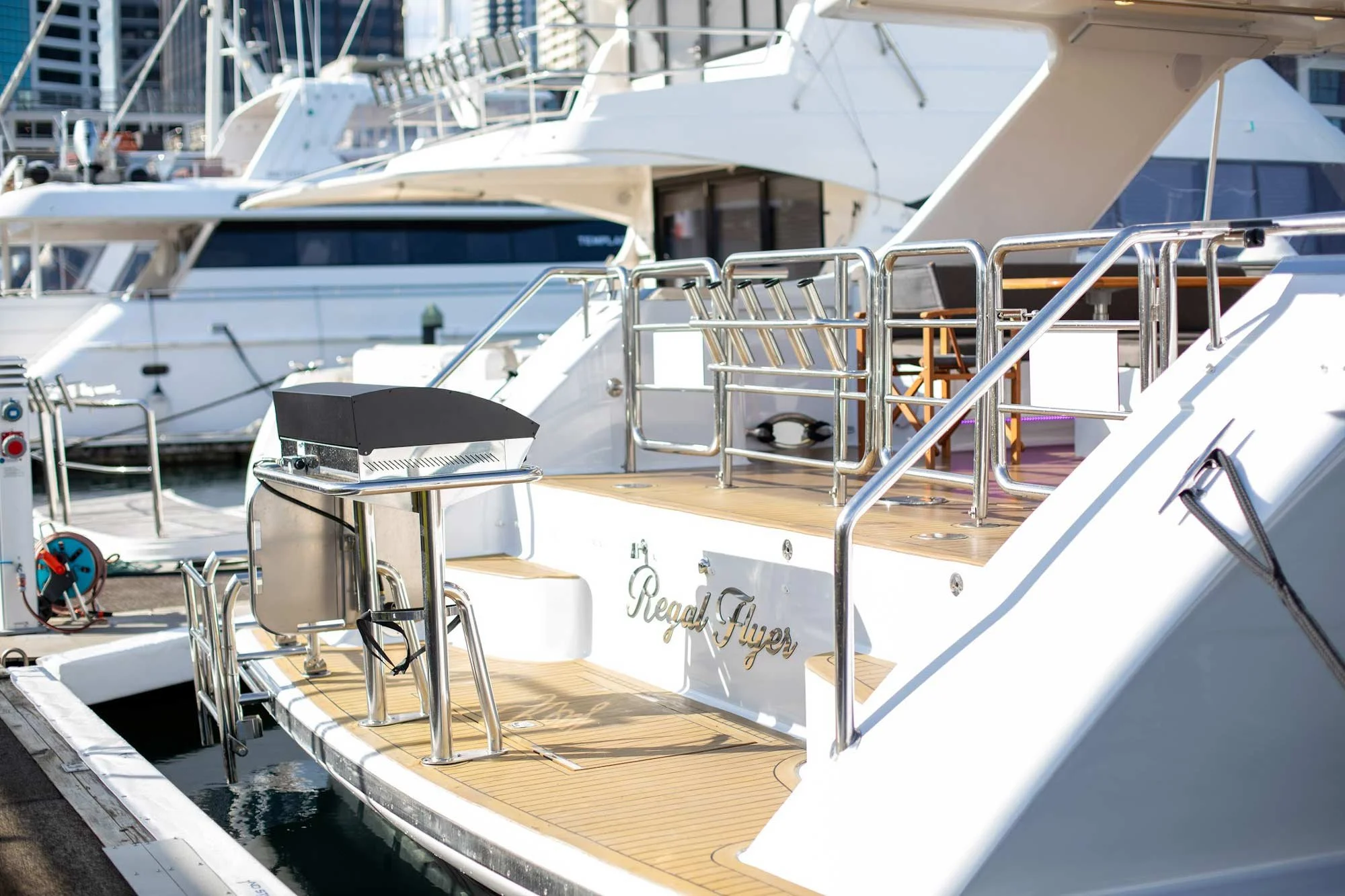 Close-up of the rear deck of a yacht named "Regal Flyer" docked at a marina.