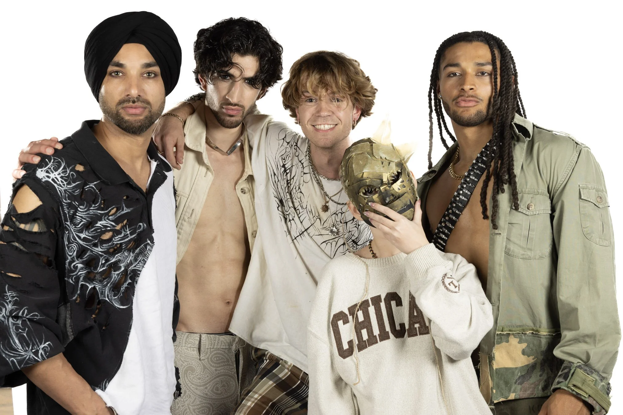 Five diverse young adults posing together against a white background, with one person holding a golden mask and wearing a cream sweatshirt with 'CHICAGO' written on it.