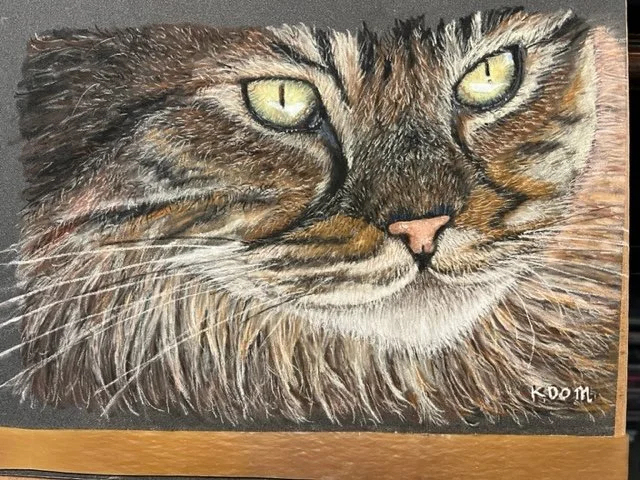 Close-up of a detailed portrait of a tabby cat with yellow eyes and brown, black, and white fur.