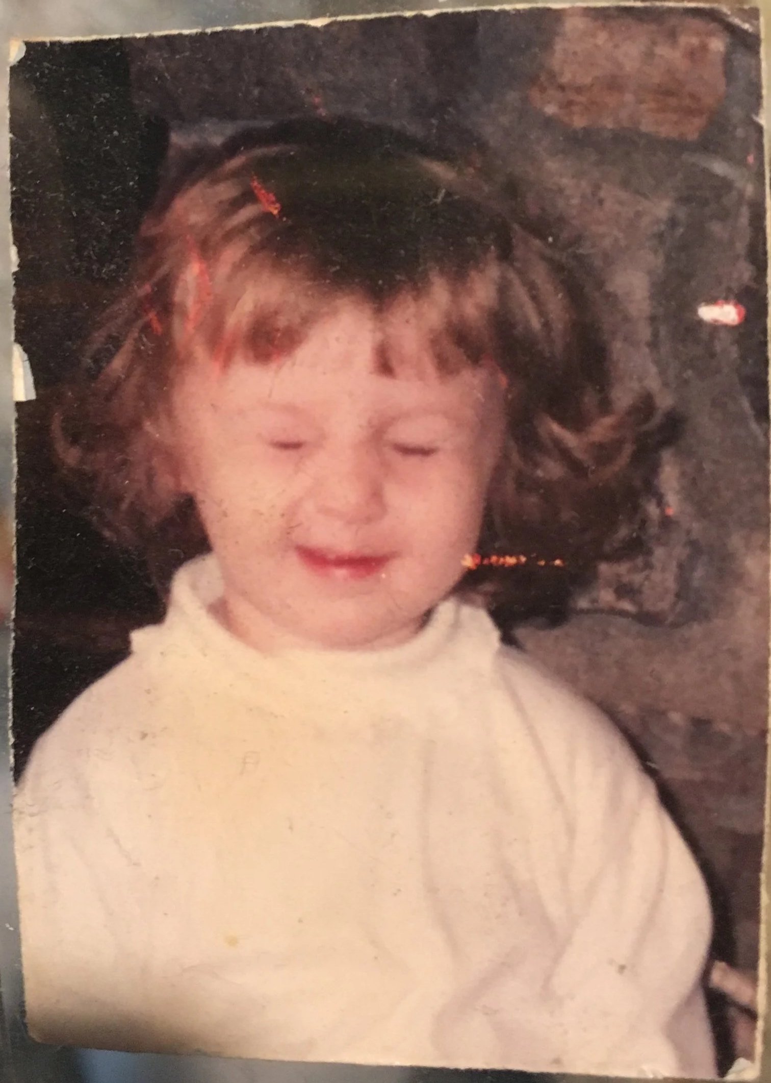 me as a kid closing my eyes during a photo