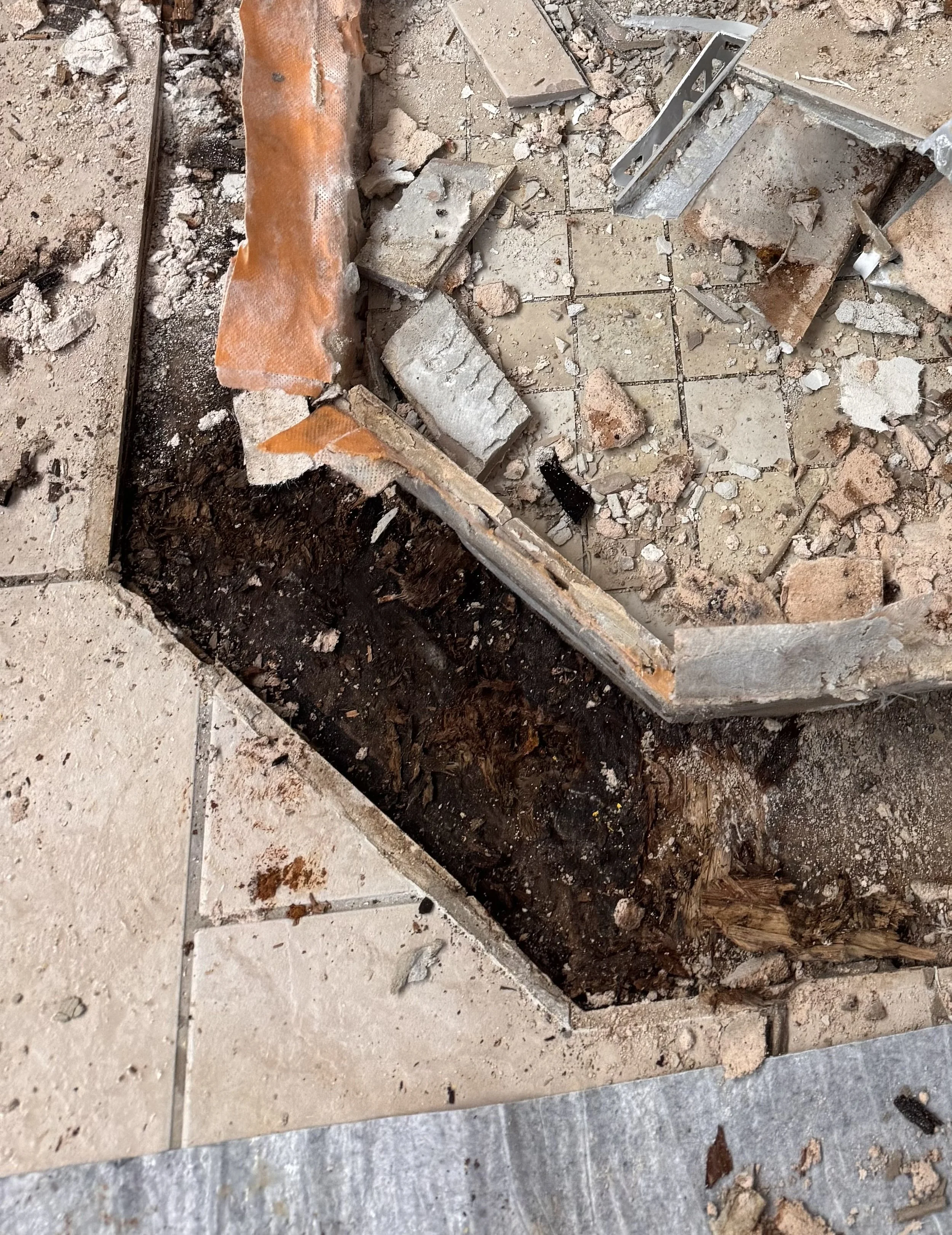Rotten shower curb and subfloor after a shower leak through cracked grout. Shower installation Halifax, Dartmouth, Bedford, Lower Sackville, Hammonds Plains, Fall River, Timberlea