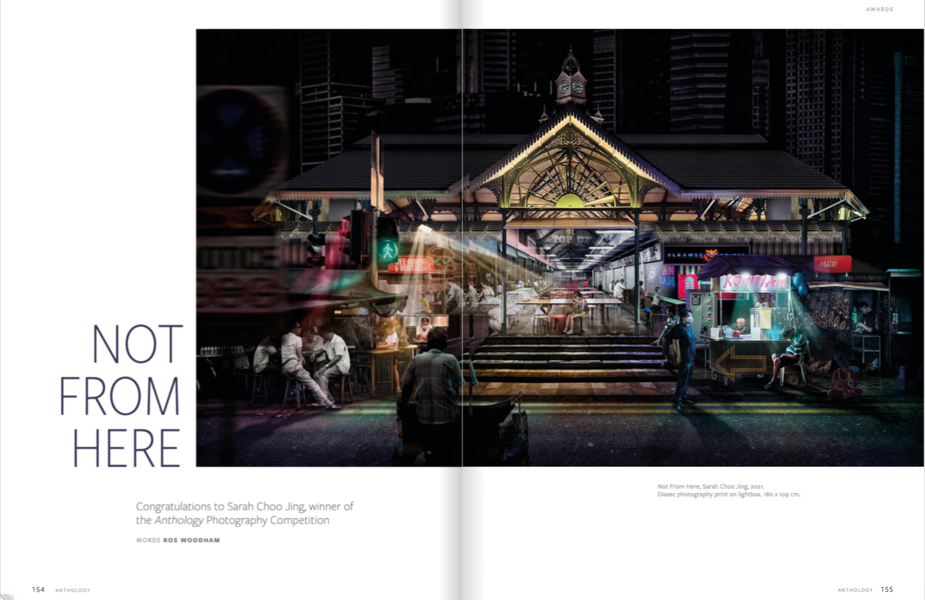 Night market scene with illuminated stalls and people sitting at tables, a vintage building with a clock tower in the background, neon signs, and city skyscrapers.