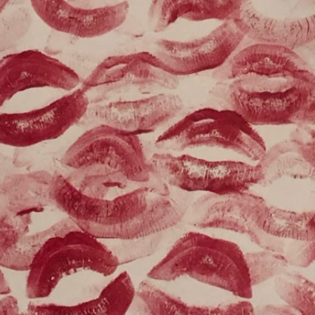 Multiple lipstick kiss marks in shades of red and pink covering the surface.