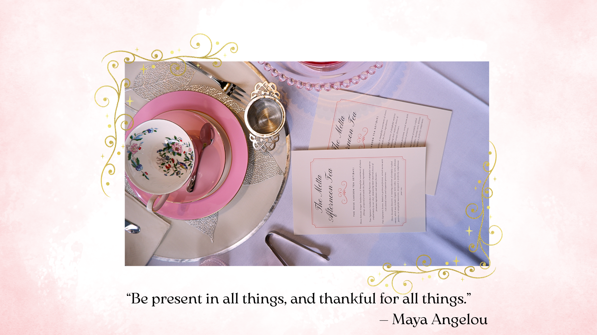 Cup of Metta place setting on a table with a floral teacup, pink saucer, pink teaspoon, gold-rimmed glass, and two printed menu cards. The background has a light pink border with gold decorative swirls and a quote below.
