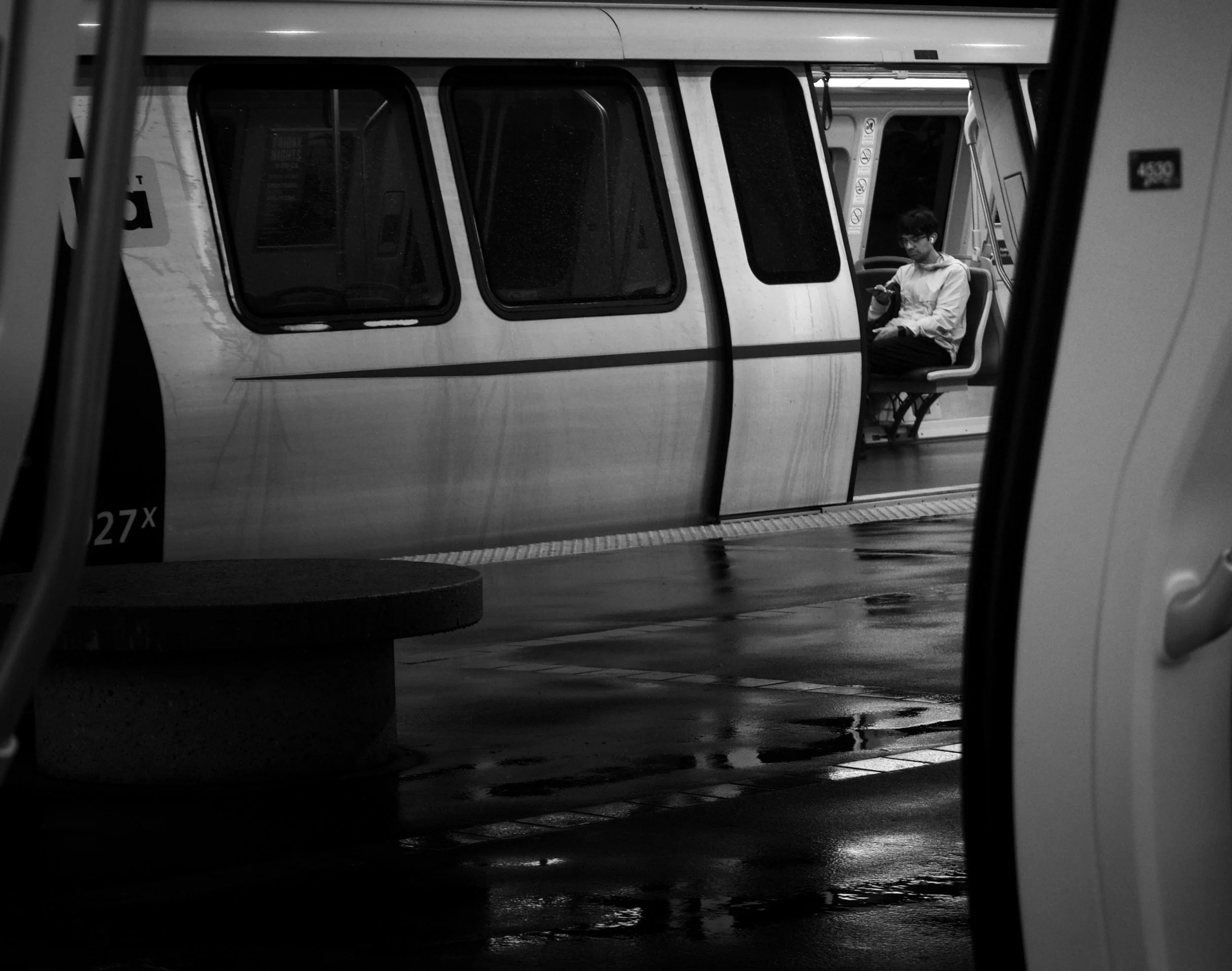  Geometry of Isolation  Moving through transit Oakland, 2026  LUMIX G85  |  Telephoto  |  Digital 