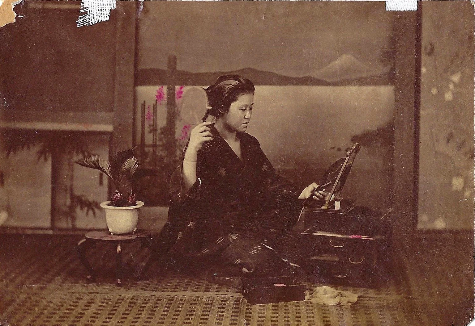 [Hand-colored photograph of a Seated Woman]. Japan, Meiji Era.