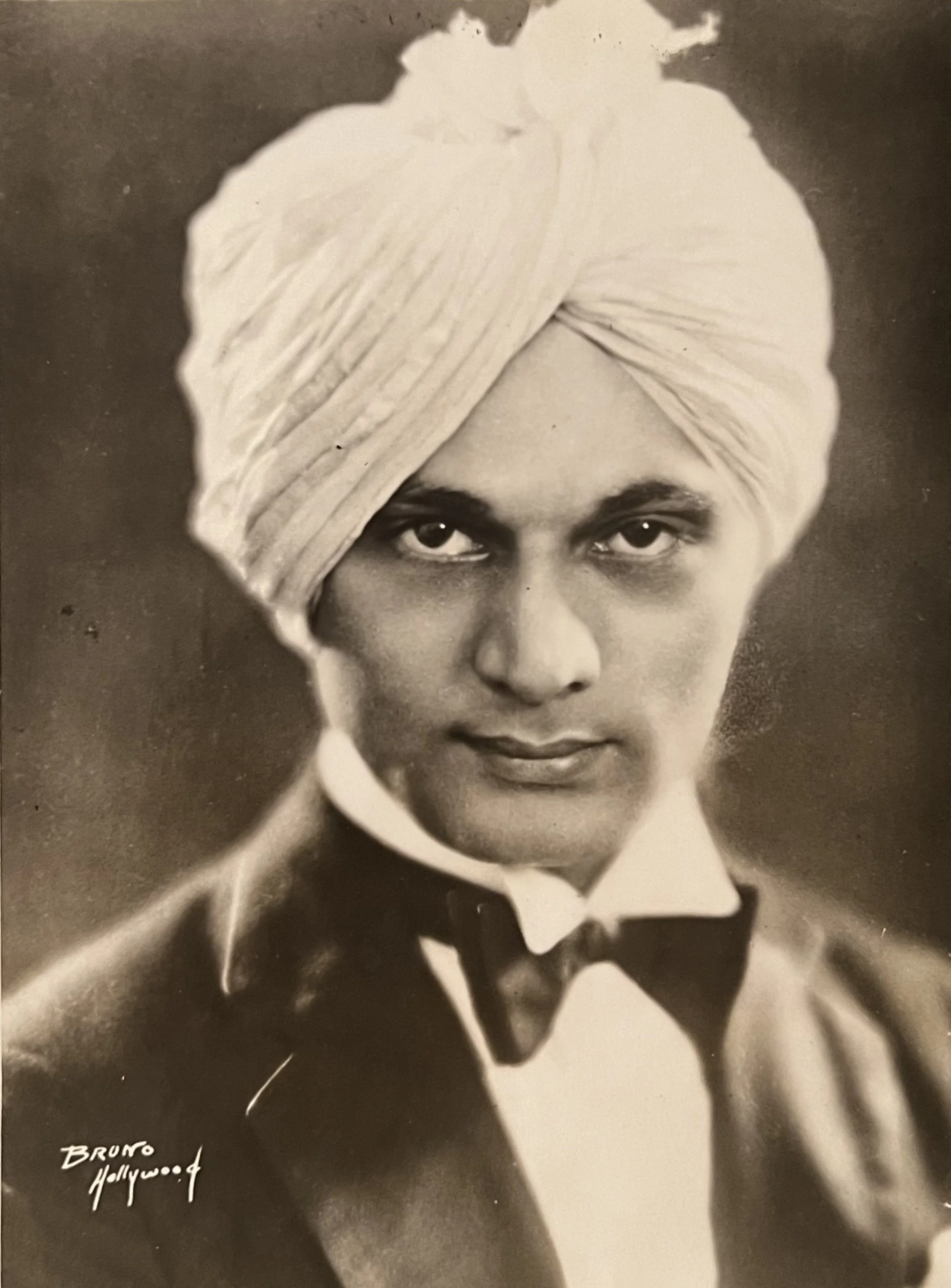 A press photograph of Maneck Anklesaria, an early Parsi immigrant and spiritual lecturer. Signed in the negative, reading "Bruno, Hollywood."