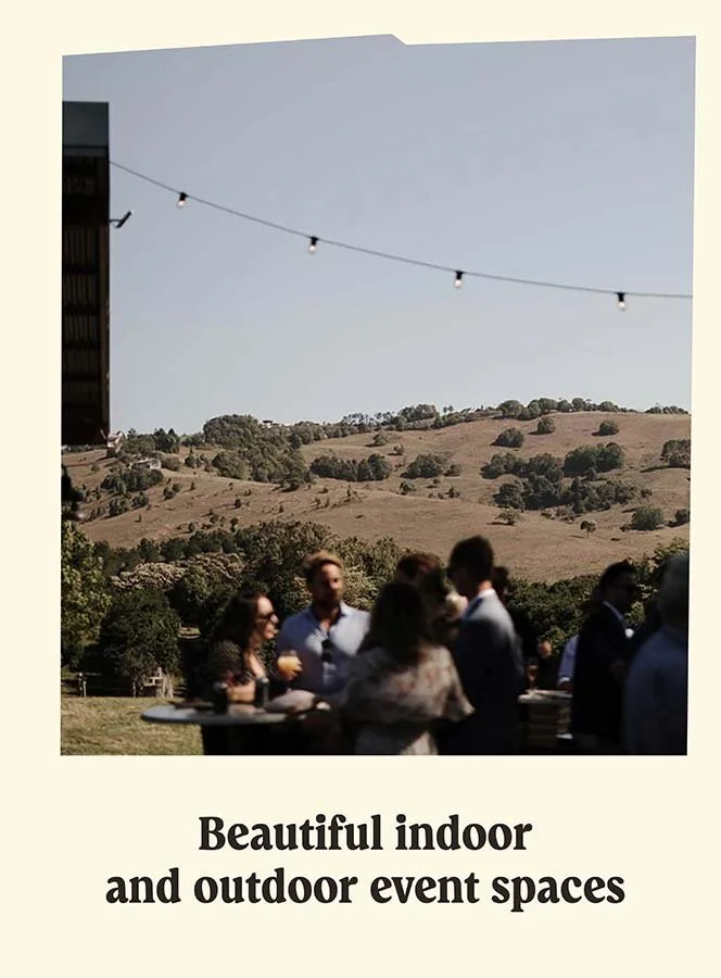 A group of people gathered outdoors during daytime, with a backdrop of rolling hills and trees. String lights are hanging overhead. The scene promotes indoor and outdoor event spaces.