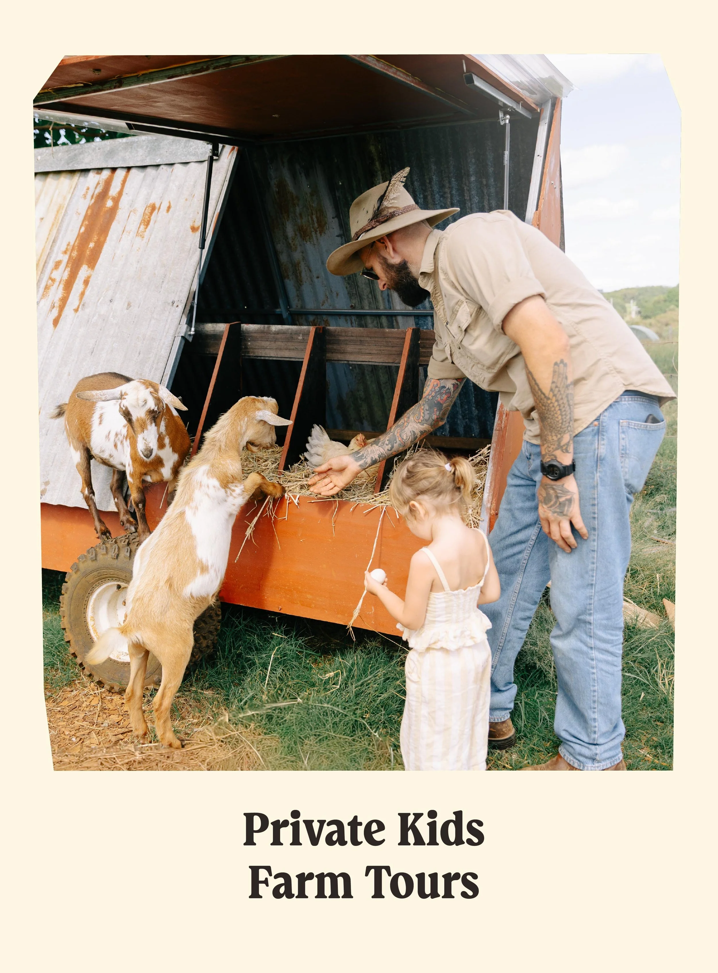 A man with tattoos and a beard, wearing a tan hat with a feather, feeding goats and kids at a farm, with a goat standing on its hind legs and a child holding a treat, in front of a rustic farm shelter.