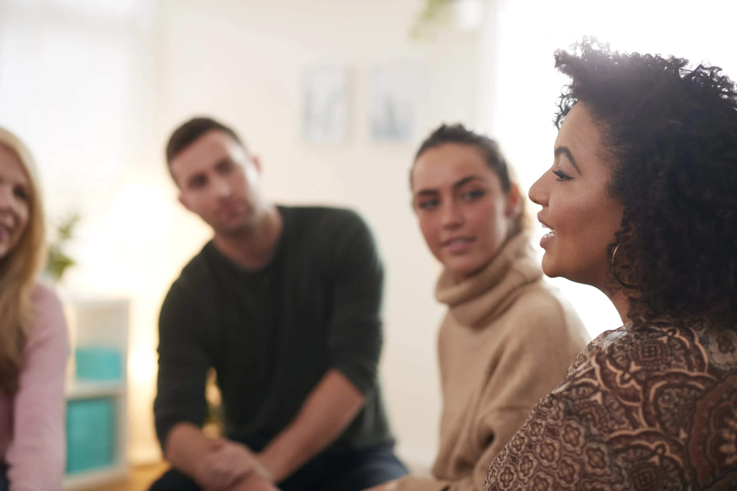 woman-speaking-support-group-meeting-mental-health-dependency-issues-community-space.jpg