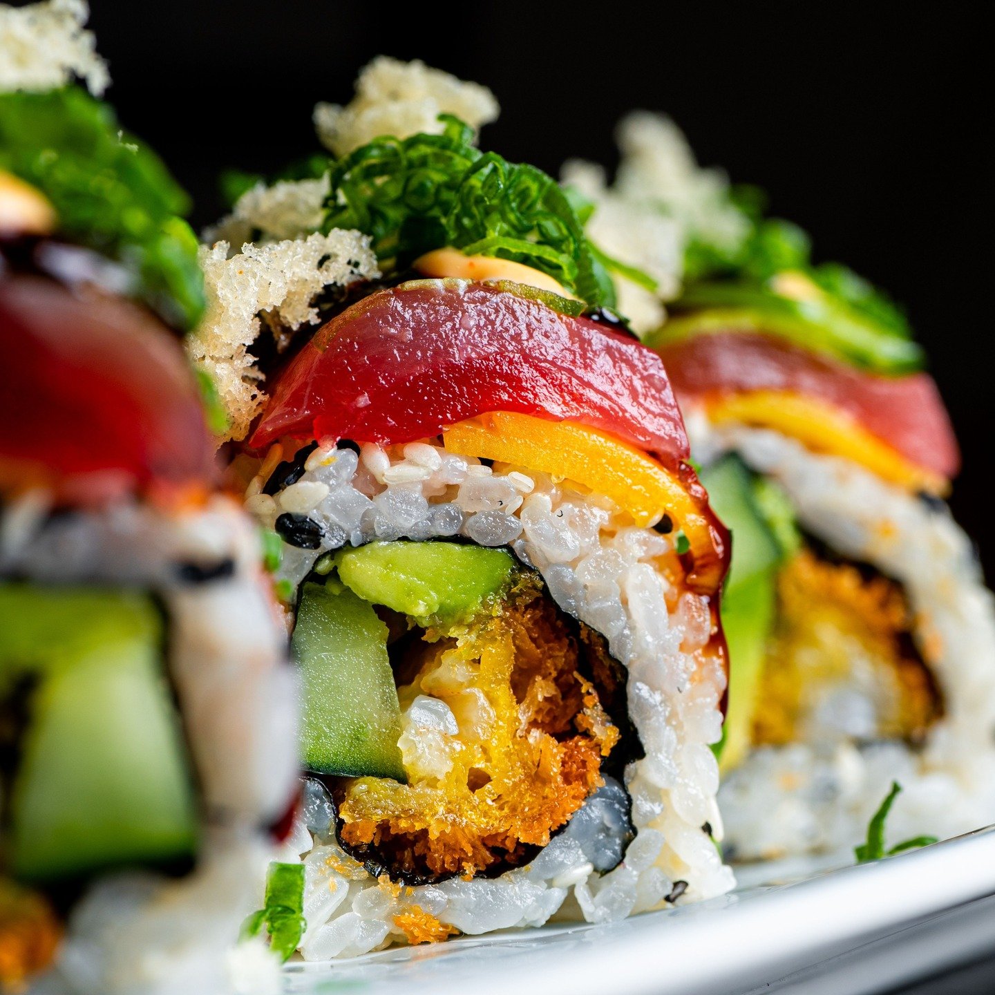 "My Wife&rsquo;s Roll"
Tempura panko shrimp layered with cucumber and avocado, finished with bigeye tuna, ripe mango, jalape&ntilde;o, and scallion. Drizzled with eel sauce, Cali sauce, and crisp tempura flakes. A roll inspired by all of my