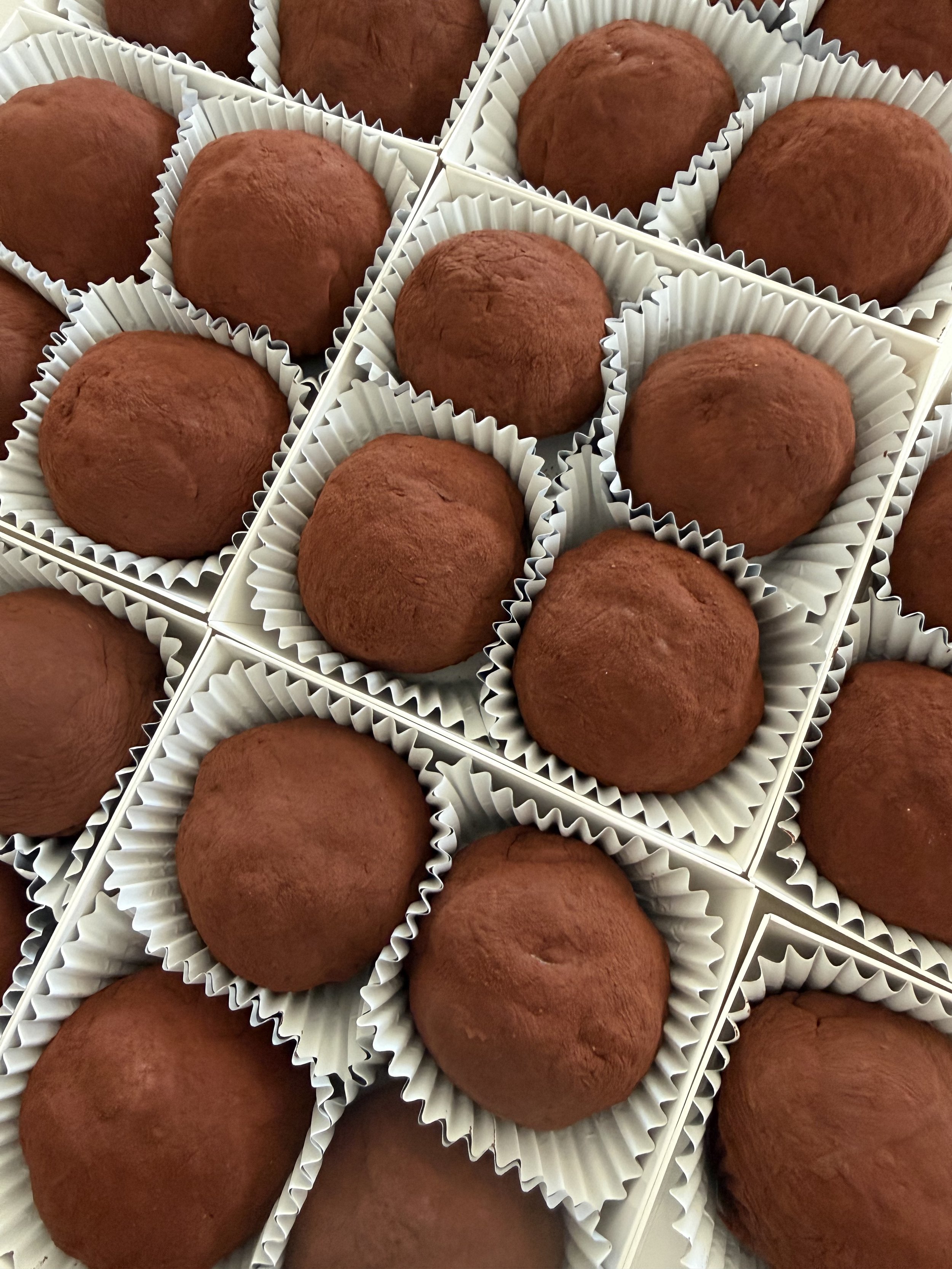 Brown chocolate pistachio cookies in a white box