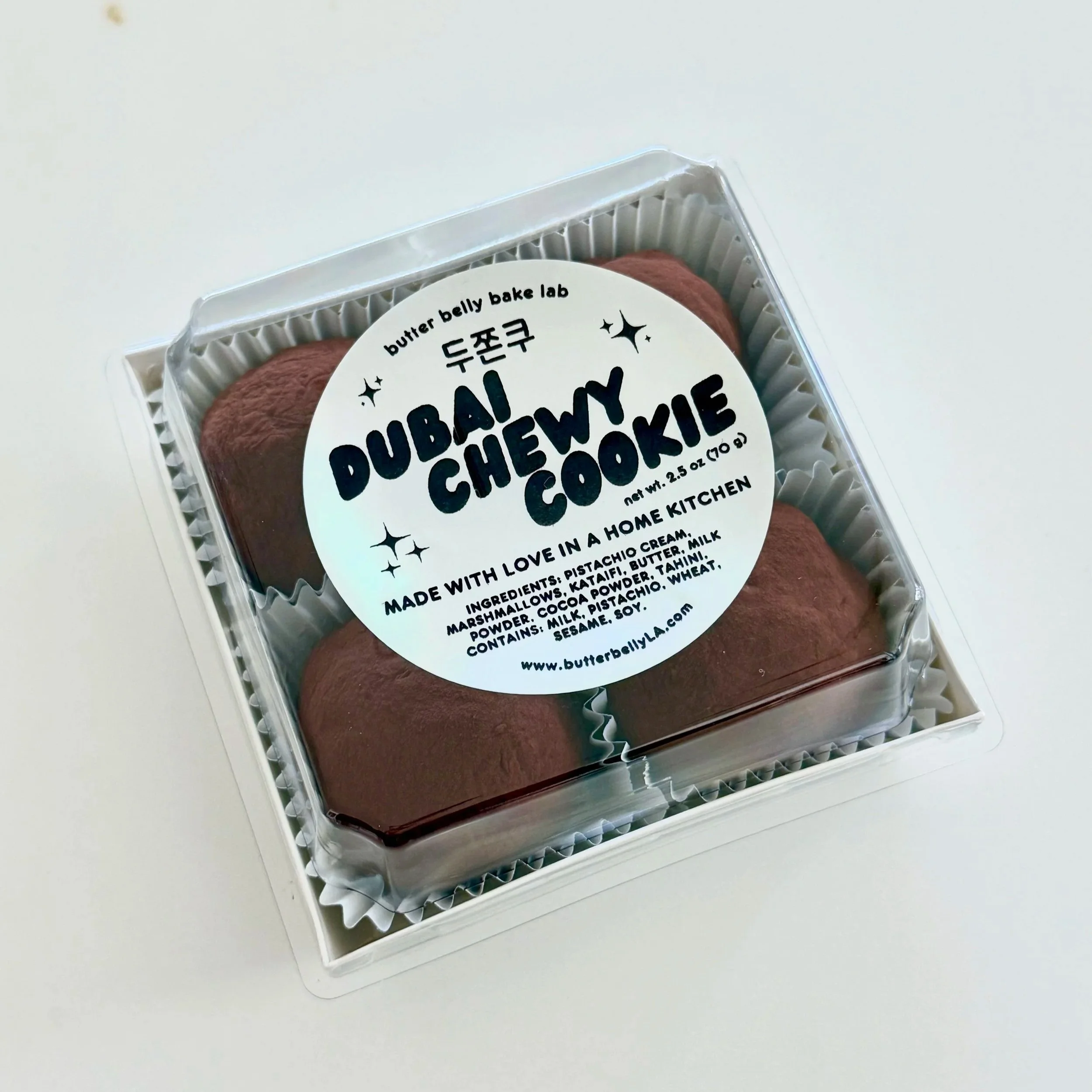 Pistachio filled chocolate cookies in a box with label