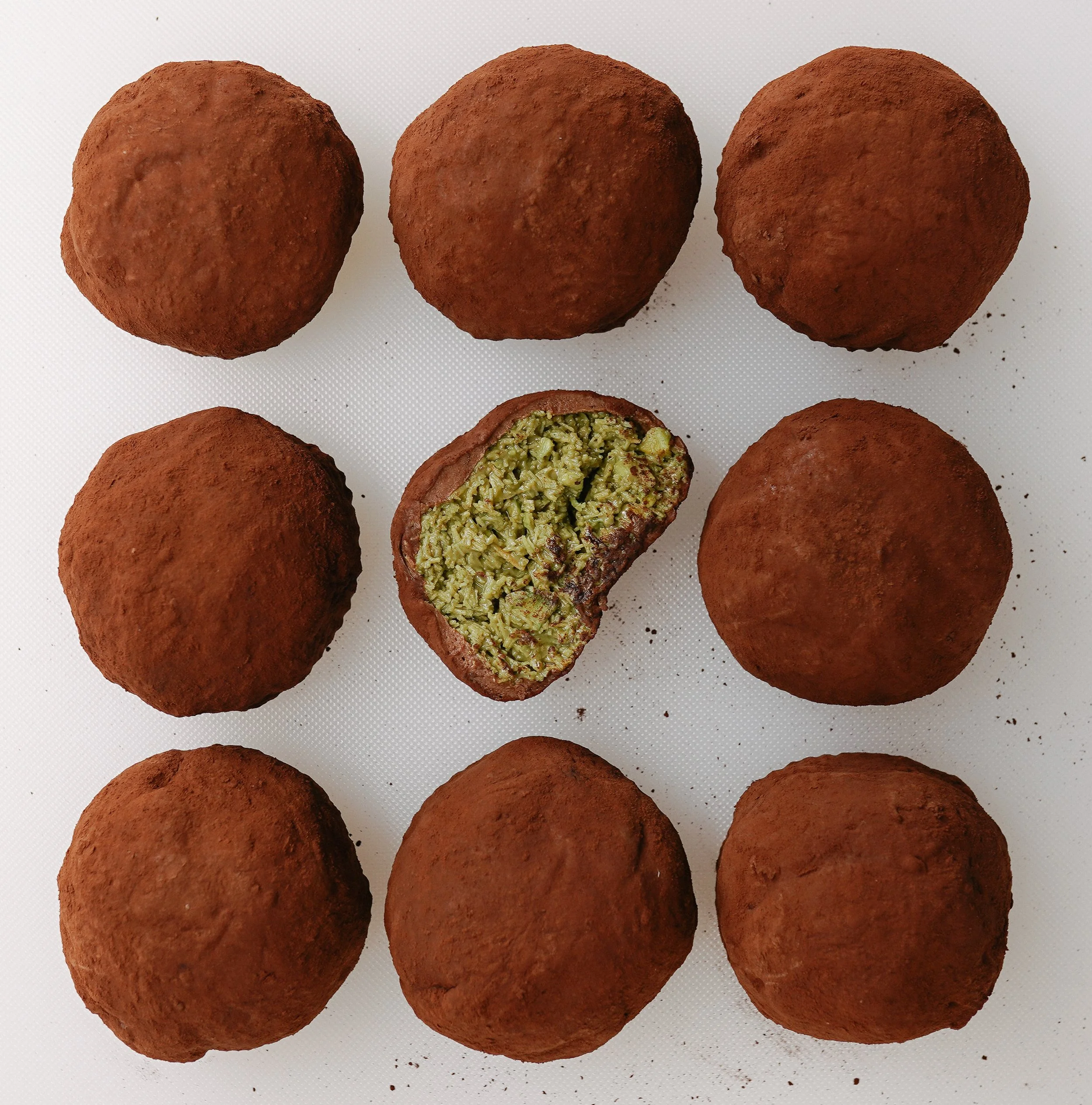 Brown chocolate pistachio cookies on a white background