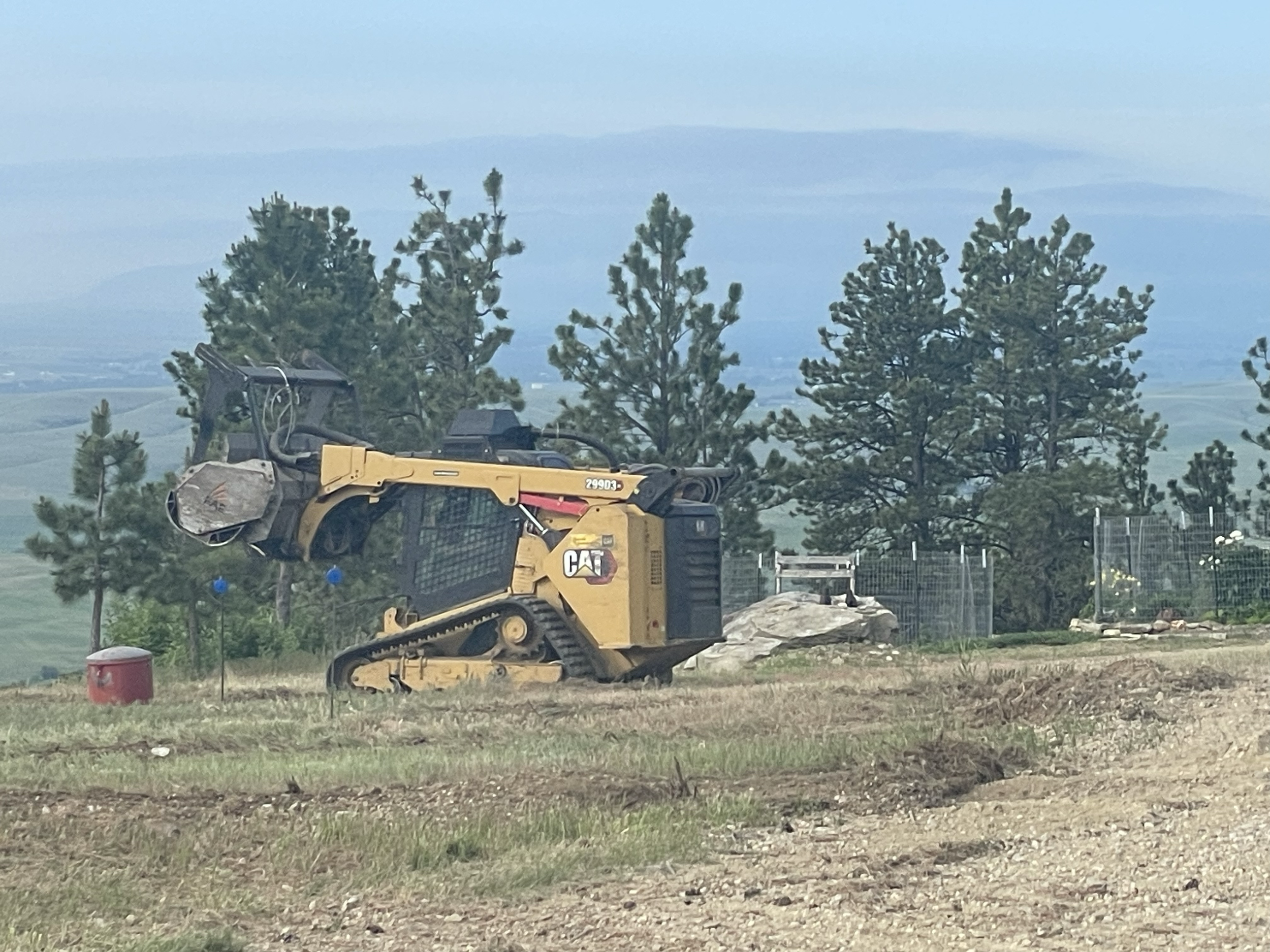 We work around infrastructure and other barriers when on customer's properties. Here, Jeff is working around not only part of their fuel supply, but we were also asked to ensure not trees fell on the burial grounds of their pets. We felt honored to w