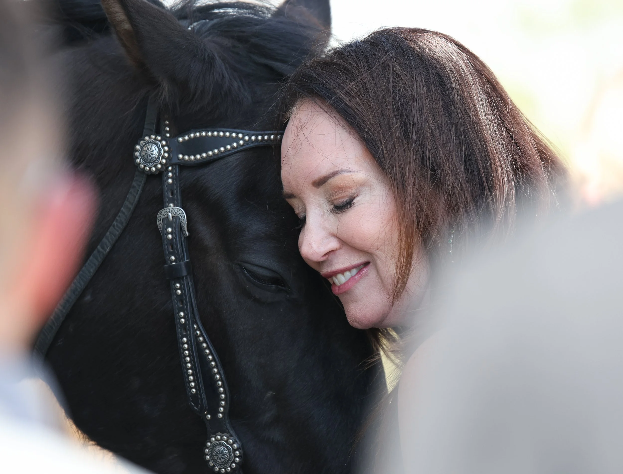 U.S. Department of Agriculture Secretary Brooke Rollins hugs Texas Tech Masked Rider’s horse – Centennial Champion – on April 16, 2025 in Lubbock, Texas. Rollins toured the USDA Agricultural Marketing Service Cotton Classification Complex in Lubbock.