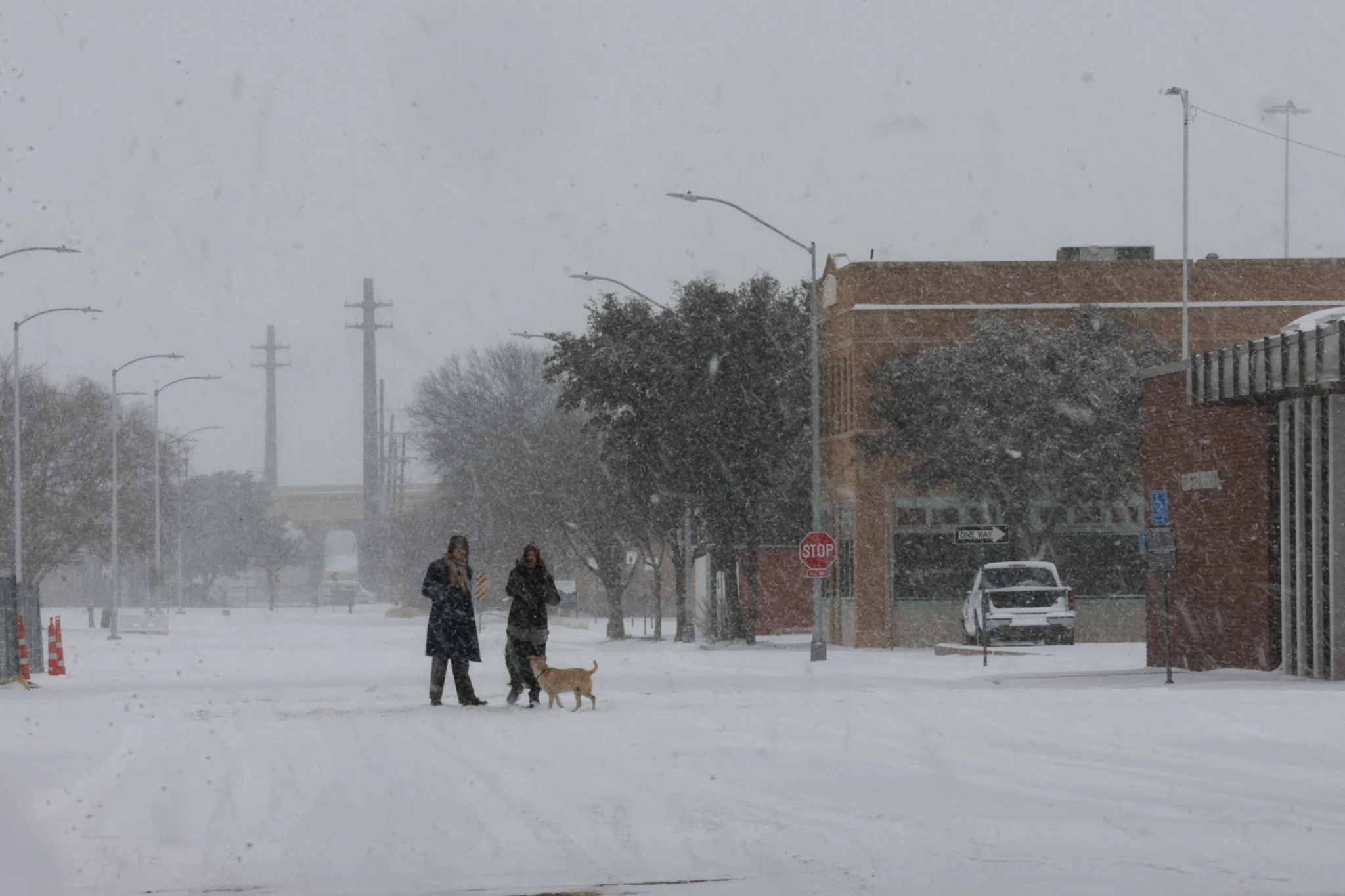 Lubbockites take photos in the snow in Downtown Lubbock during Winter Storm Fern on Jan. 25, 2026 in Lubbock, Texas.
