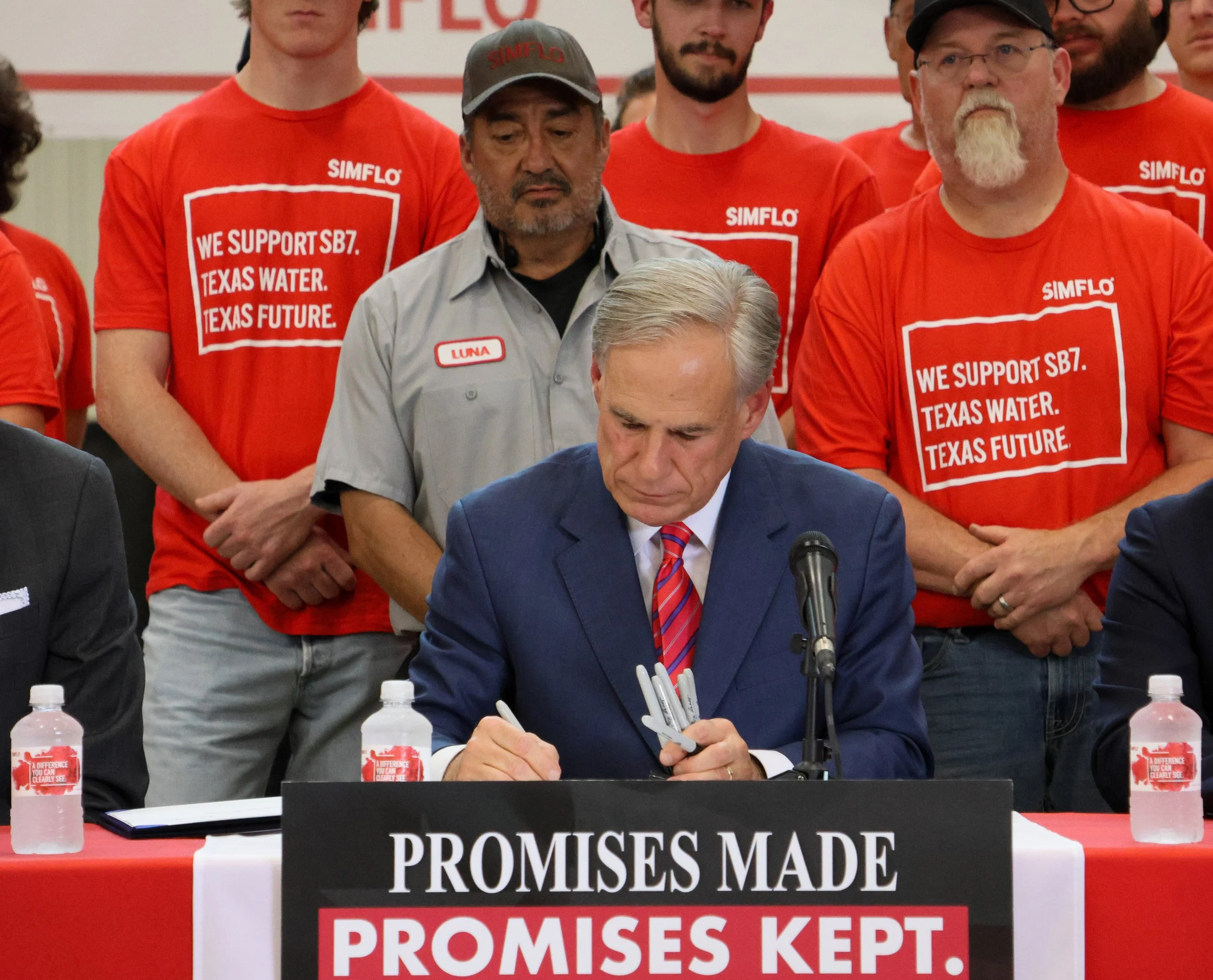 Texas Gov. Greg Abbott signs two bills during a ceremony at SIMFLO's Engineering Products Facility — 605 26th Street — on June 18, 2025 in Lubbock, Texas. Bills would help create a or a $20 billion water investment fund to help secure Texas's water f