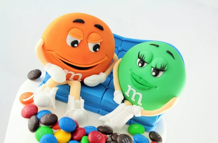 M&M Wedding Cake (top) - Weddings are such a wonderful celebration. So why not have a bespoke wedding cake? This fun M&M cascade novelty cake will have your guests talking years after the big day.