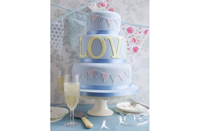 Love Wedding Cake - This 'Love' wedding cake is perfect for a garden party wedding. The bunting just brings fun to this cake.