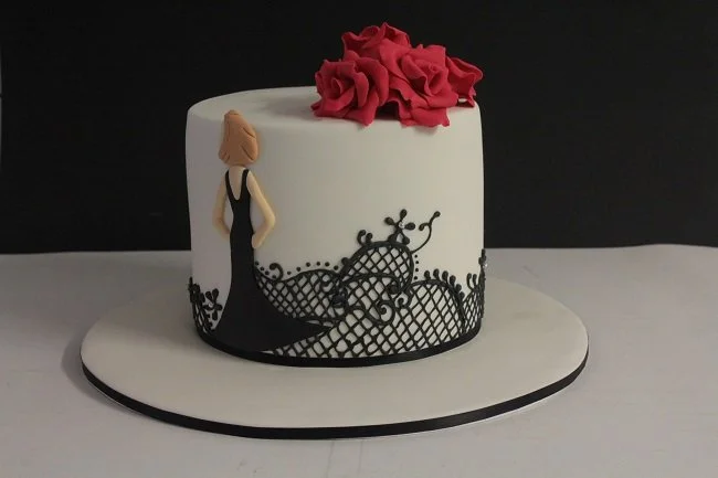 Evening Elegance - This stunning cake is adorned with handmade sugar roses and black piped royal icing