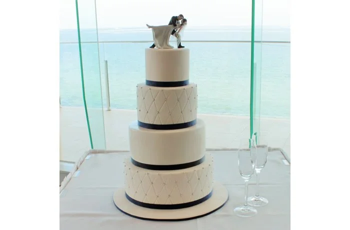 Embossed Chic - This wedding cake is classic in style. The simplistic lines display an elegance to this cake. Why not personalise your wedding cake with Bride and Groom Toppers?