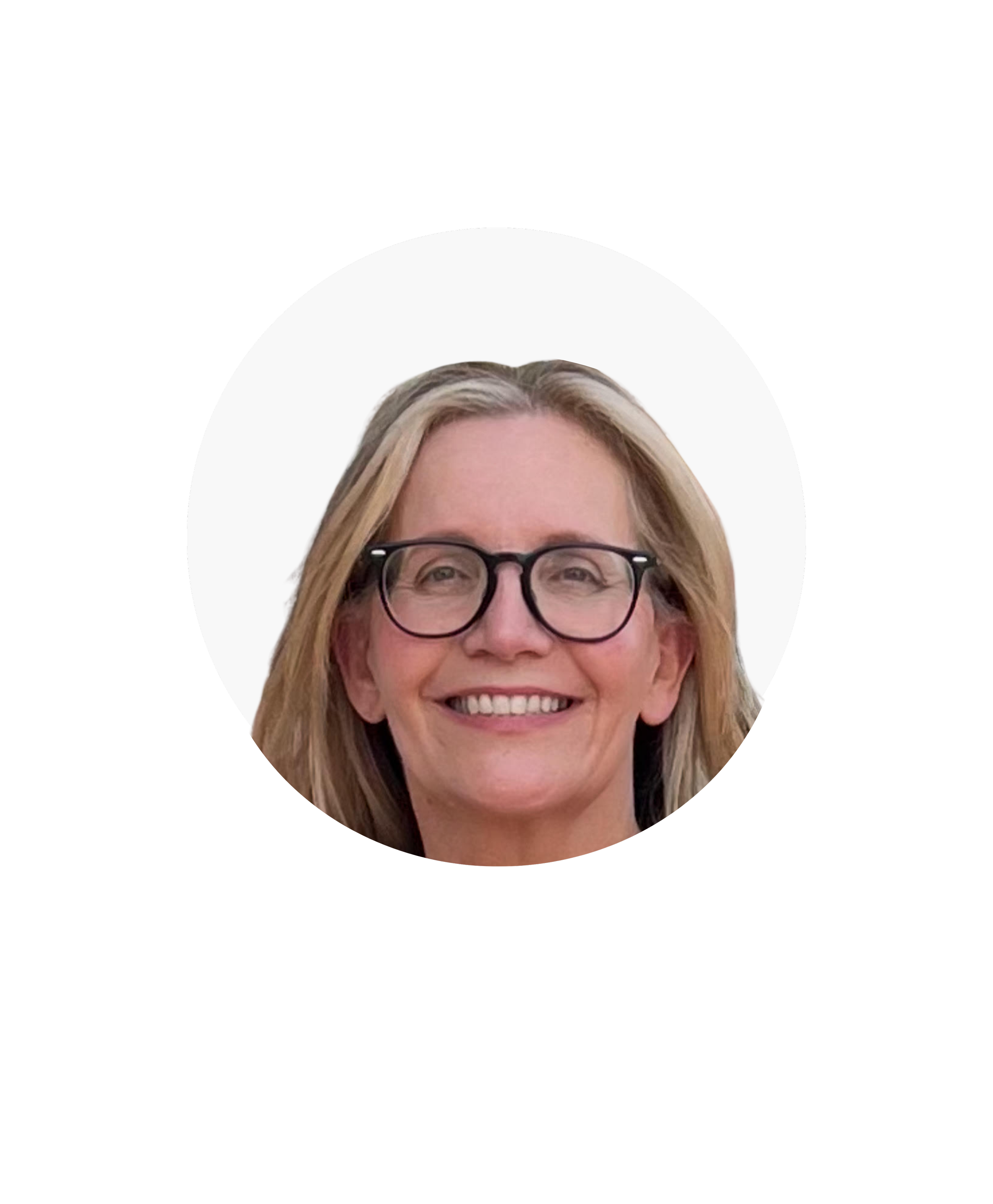 A smiling woman with blonde hair, wearing glasses, against a white background.