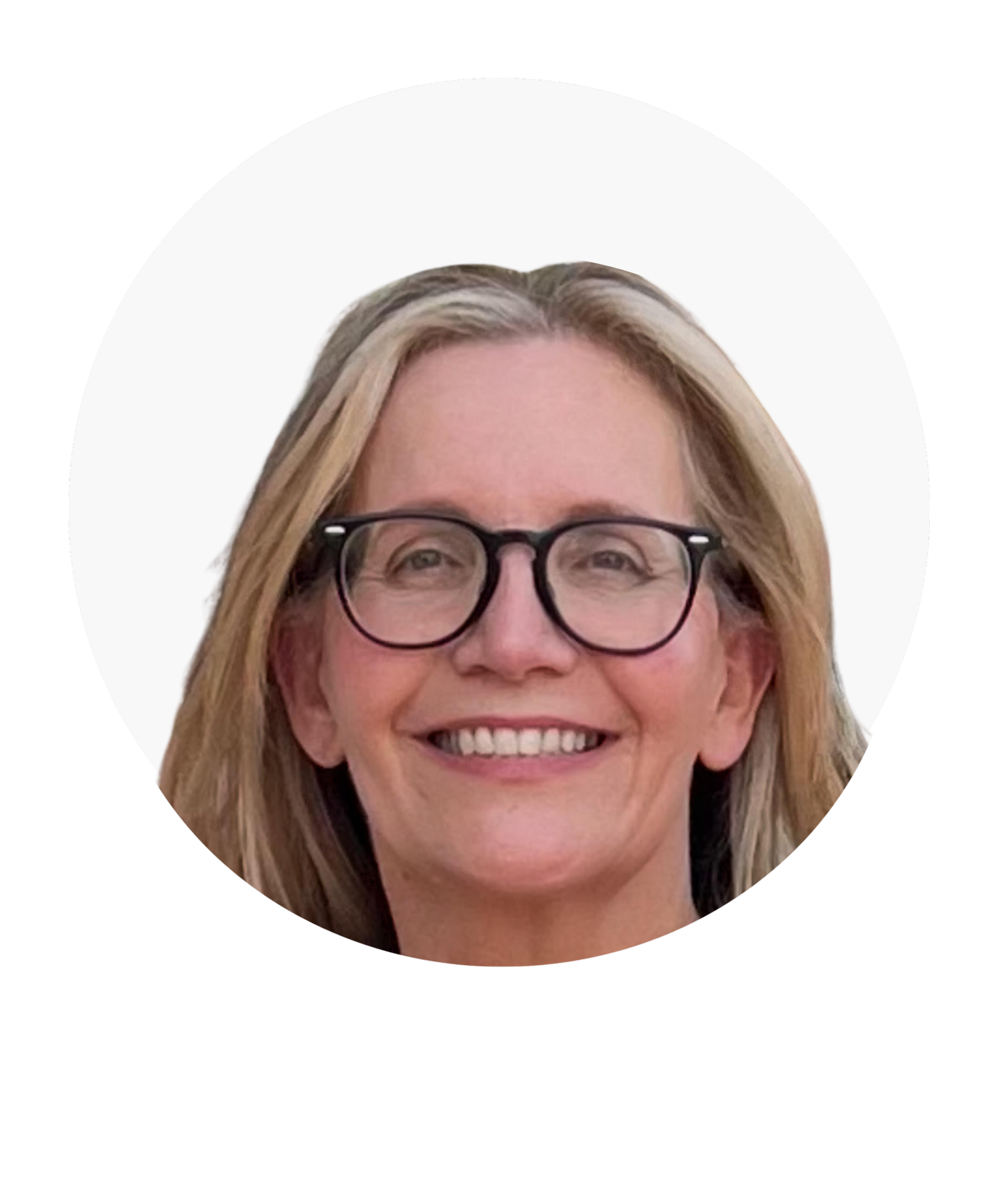 Smiling woman with glasses and blonde hair.