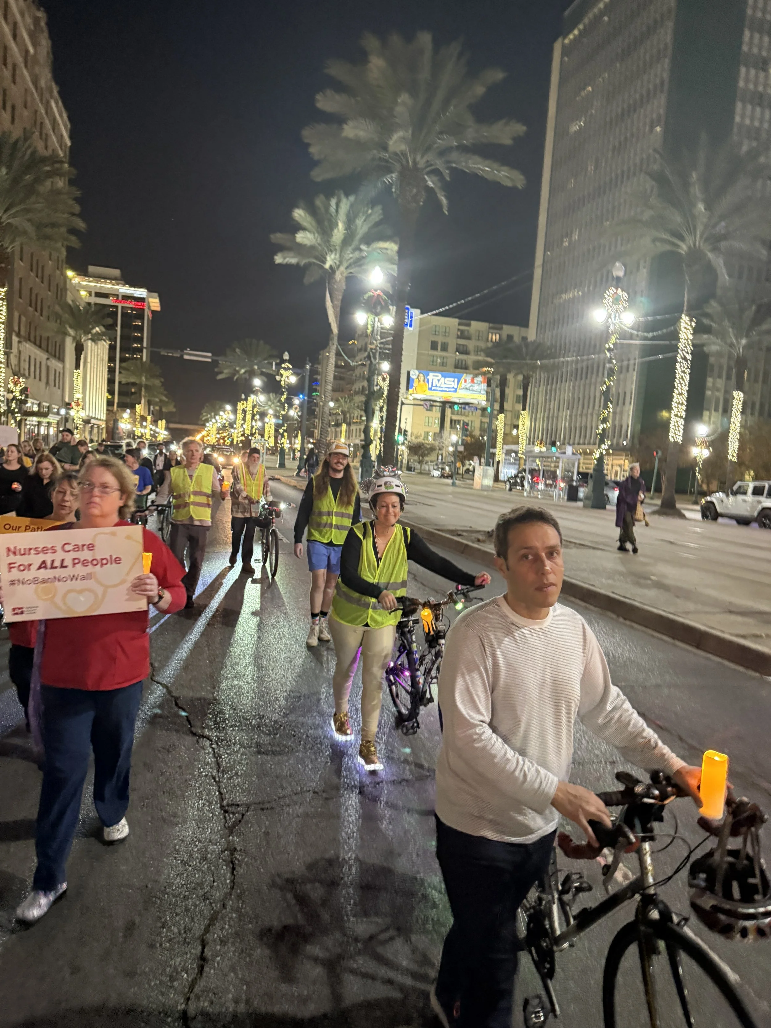 Critical Mass Nola and other bicyclist of good will creating a protective barrier for the Posada on Canal Street.