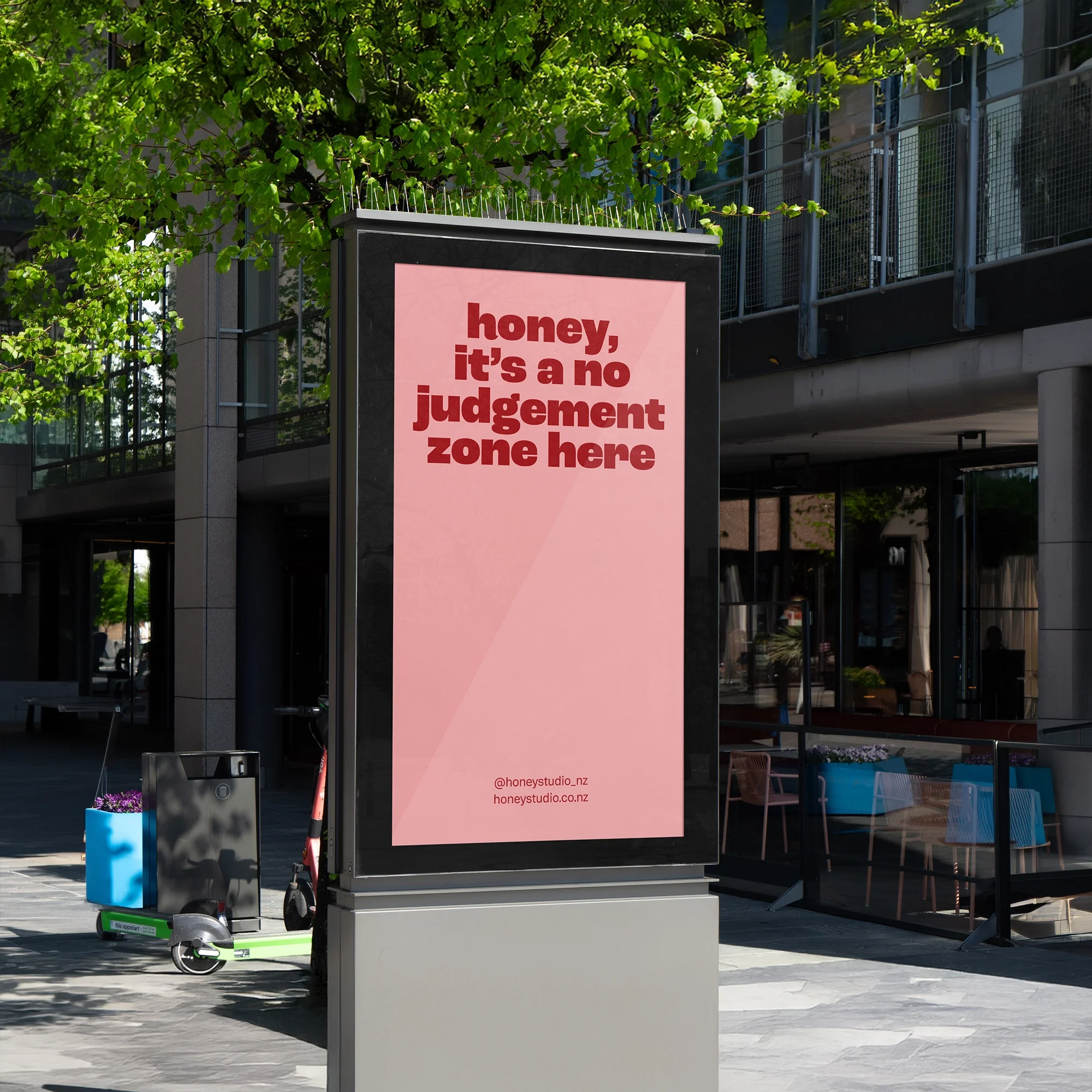 Honey nail studio outdoor advertising poster reading 'honey, it's a no judgement zone here' displayed on a street-side billboard.