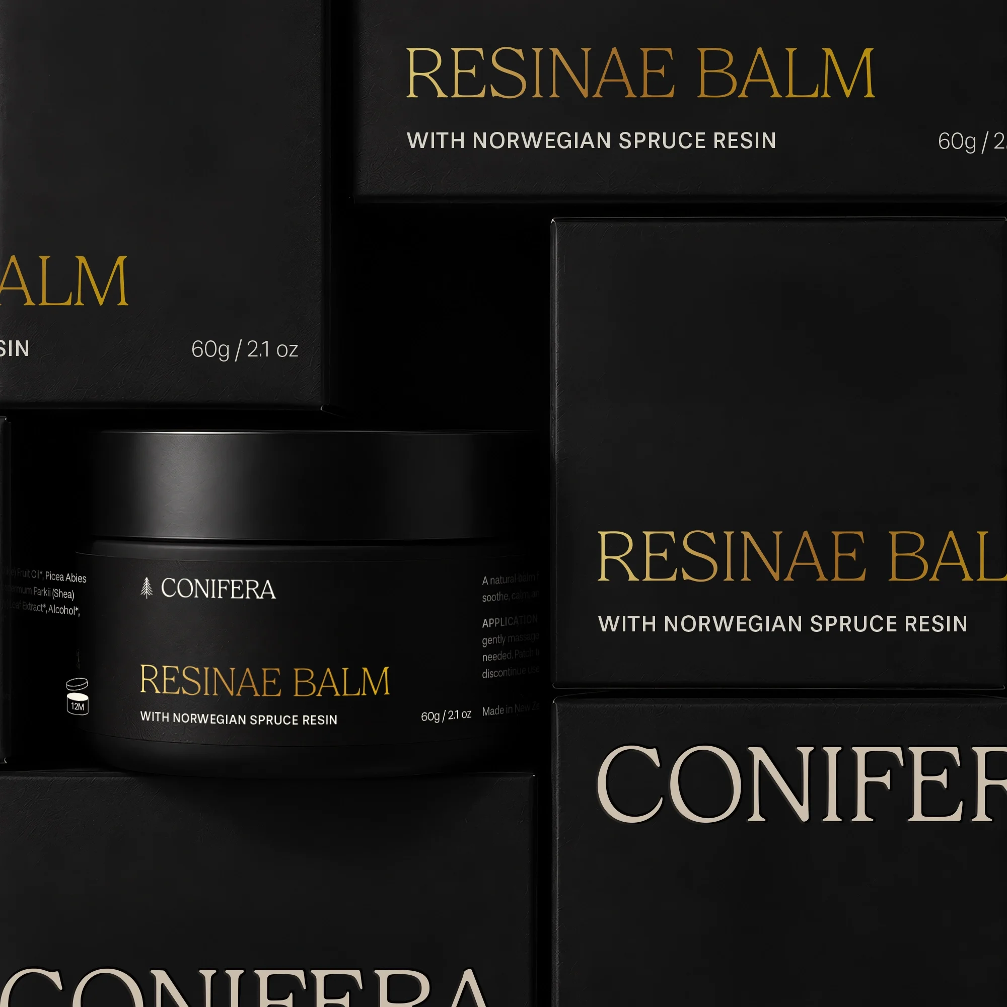 Close-up of Conifera Resinae Balm packaging and jar labels, showing repeated gold and cream serif branding on black boxes.